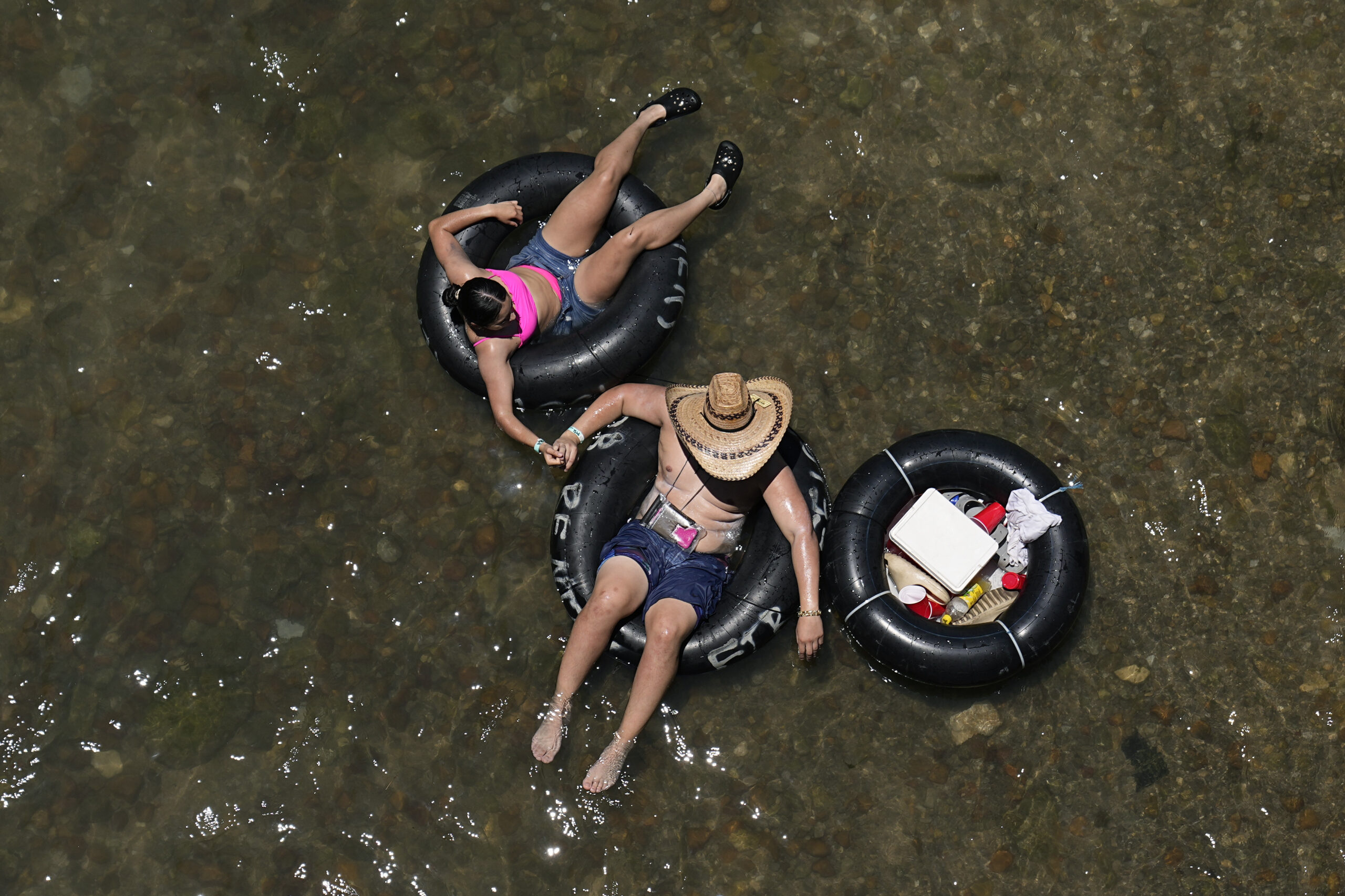 Tubers float the cool Comal River in New Braunfels, Texas, Thursday, June 29, 2023. Meteorologists ...