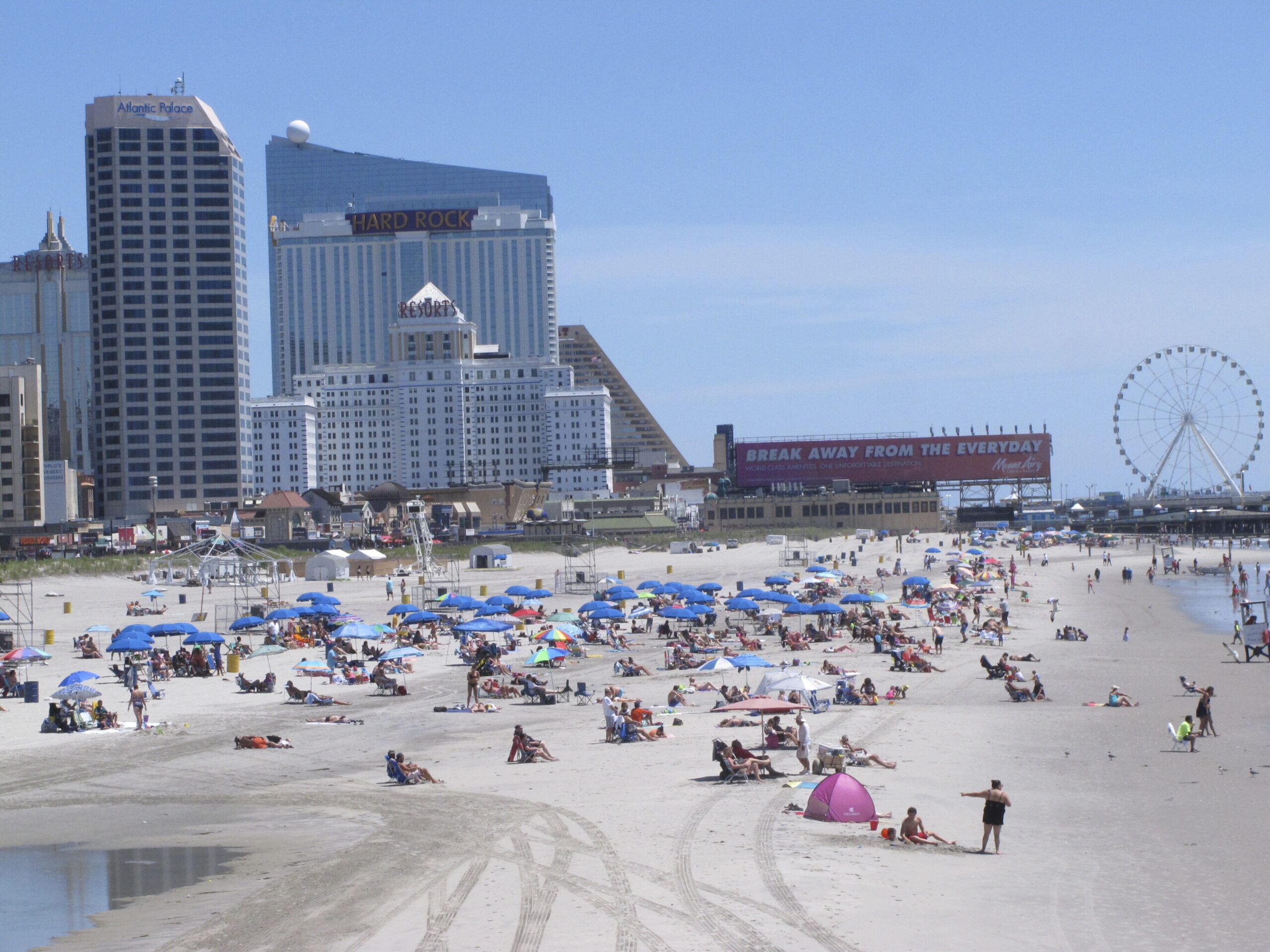People bask in the sun at the Atlantic City, N.J., beachfront, July 9, 2018. In a move made without...