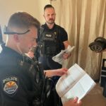Officers paid close attention to the AC unit device manual to make sure they did the job correctly. (Surprise Police Department photo)