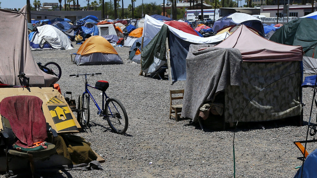 FILE - A large homeless encampment is shown in Phoenix, on Aug. 5, 2020. The city of Phoenix is sch...