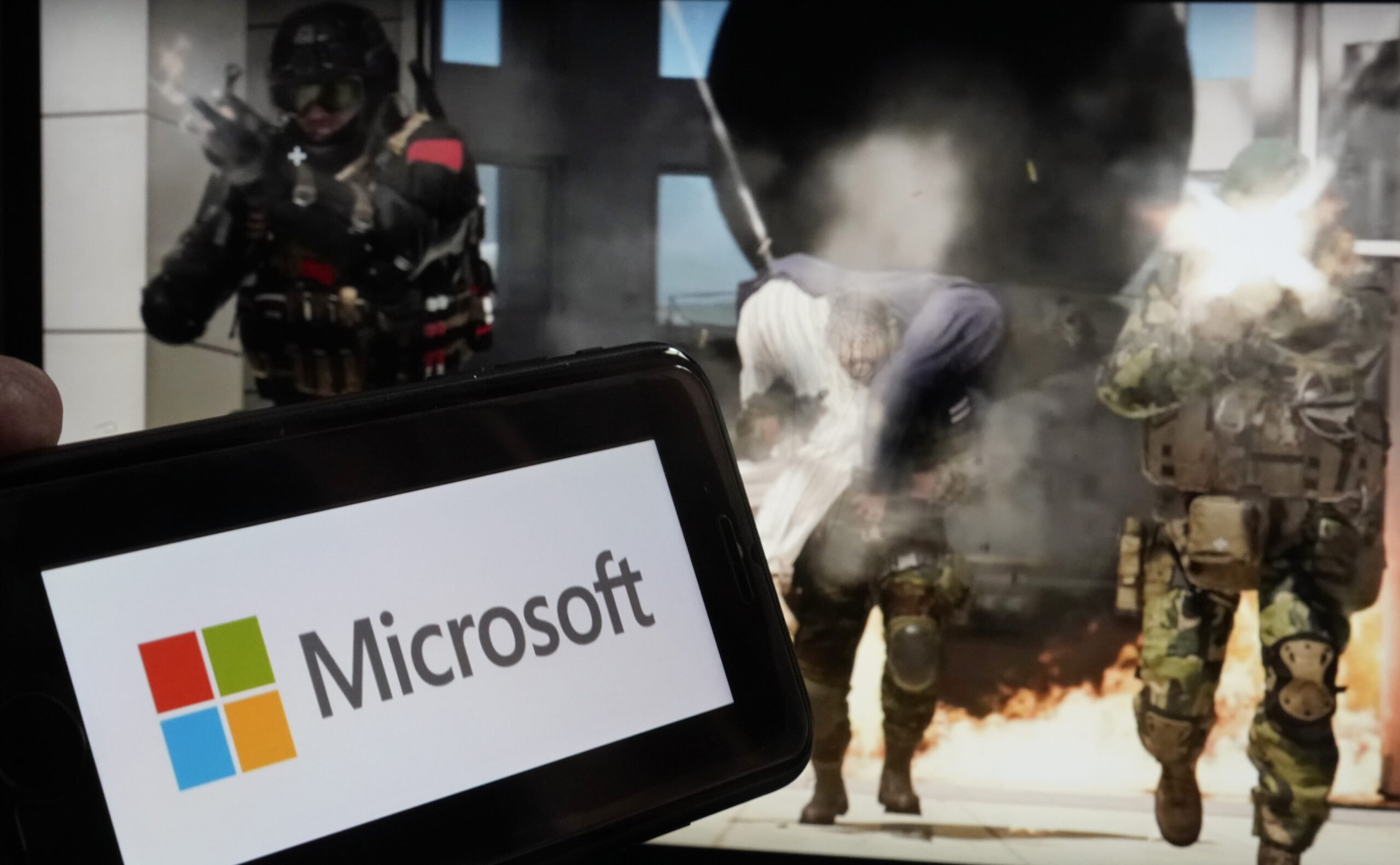 File - The logo for Microsoft, and a scene from Activision "Call of Duty - Modern Warfare," are sho...