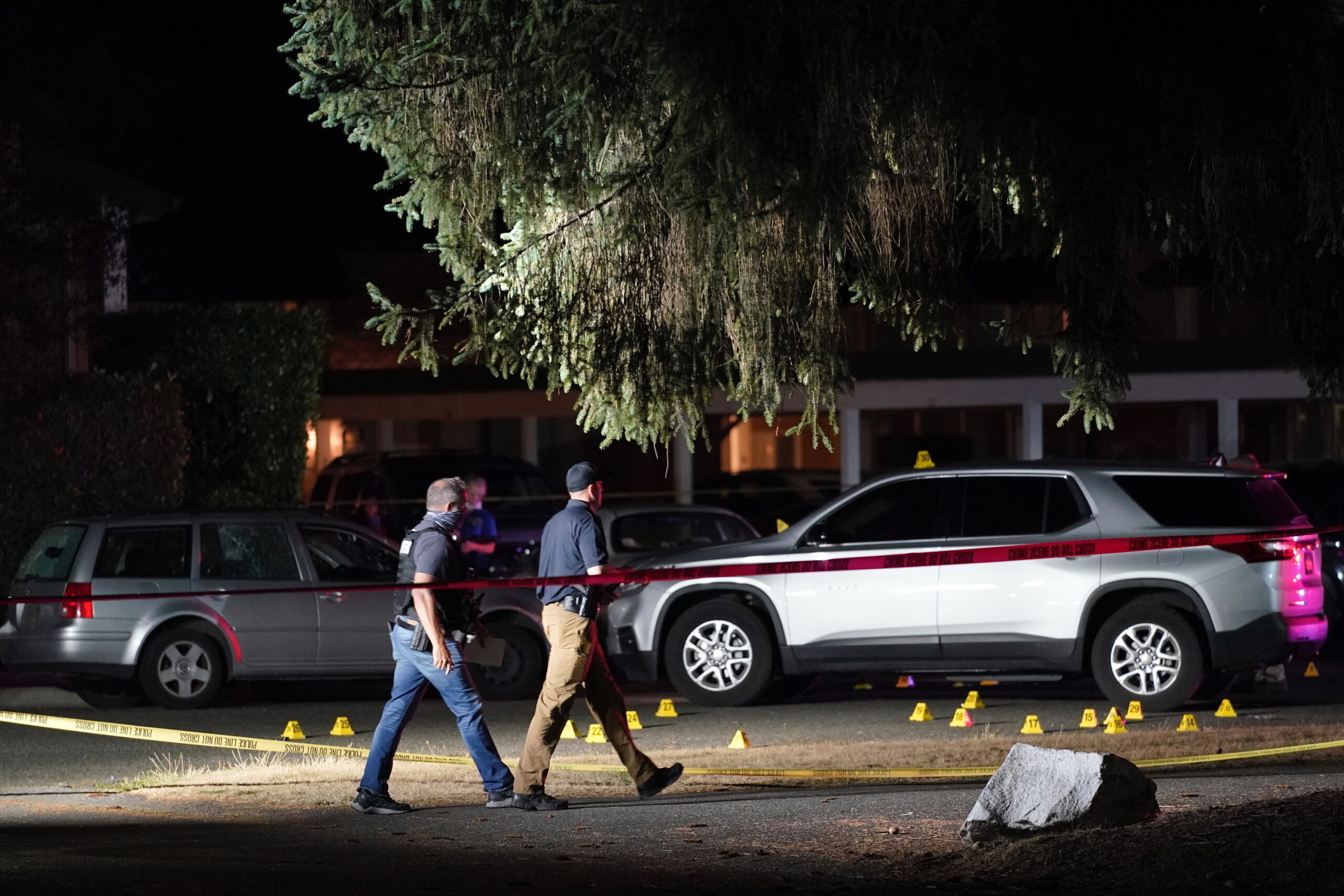 FILE - Police walk past evidence markers at a scene on Sept. 3, 2020, in Lacey, Wash., where Michae...