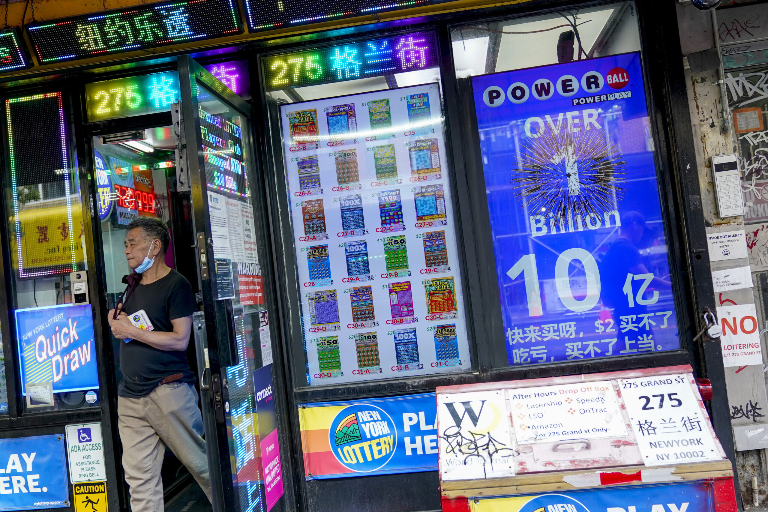 An electronic sign hanging at a convenience store announces a Powerball jackpot exceeding 1 billion...