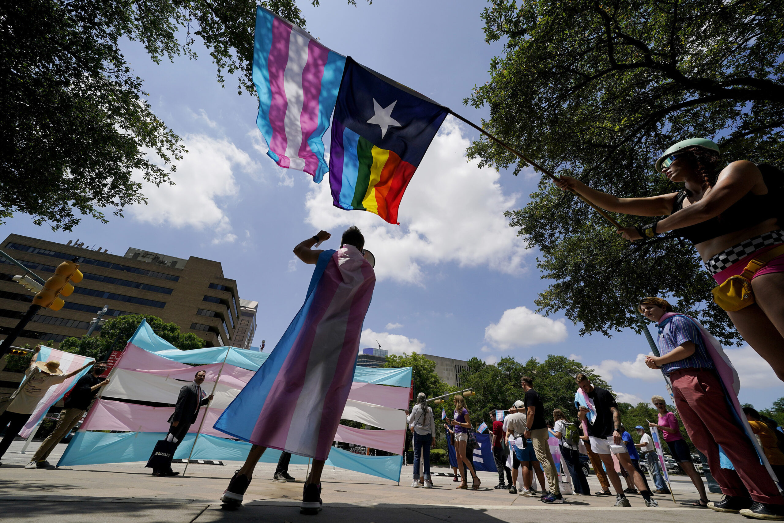 FILE - Demonstrators gather on the steps to the Texas Capitol to speak against transgender-related ...