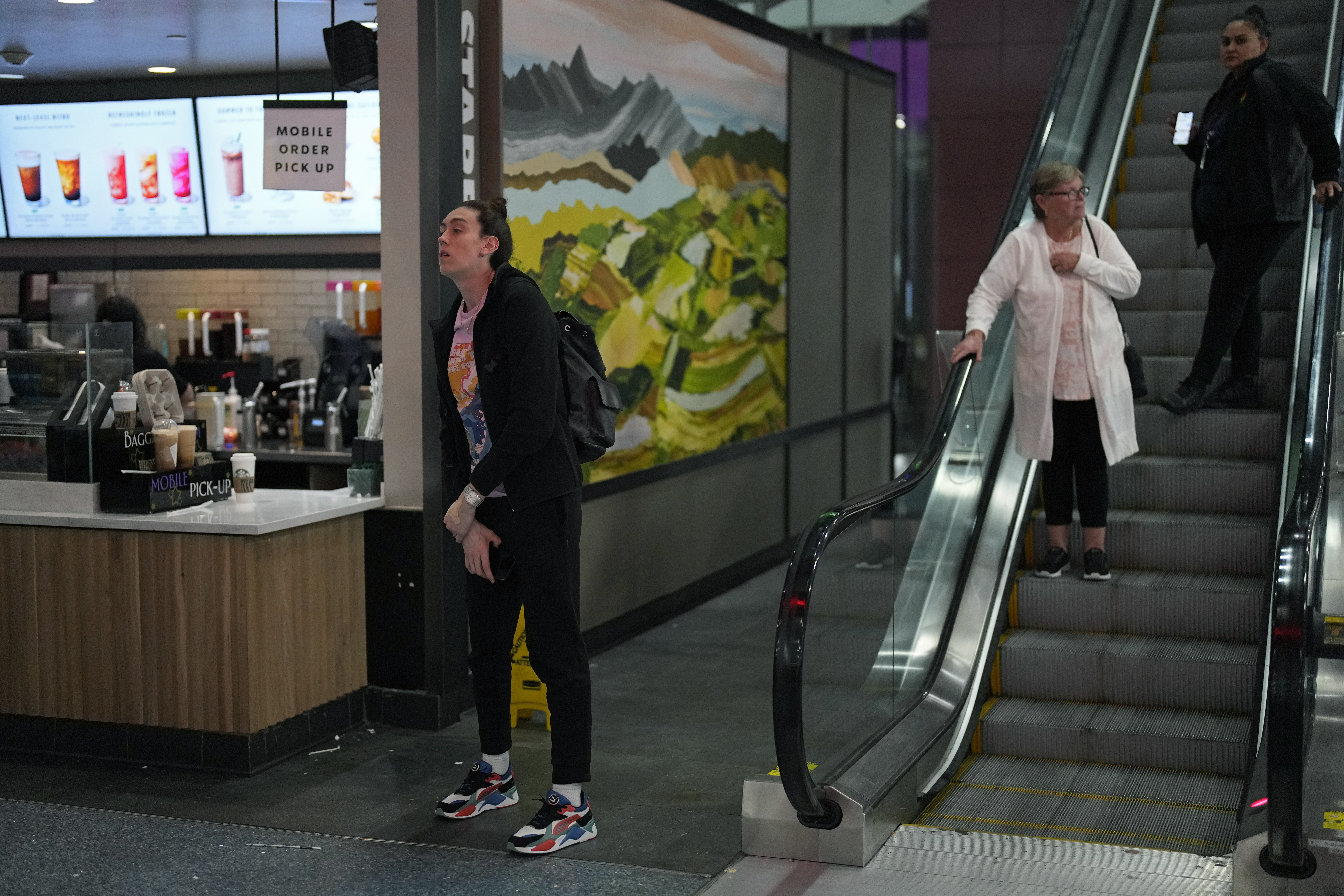 Breanna Stewart, left, of the New York Liberty WNBA basketball team waits for coffee after travelin...