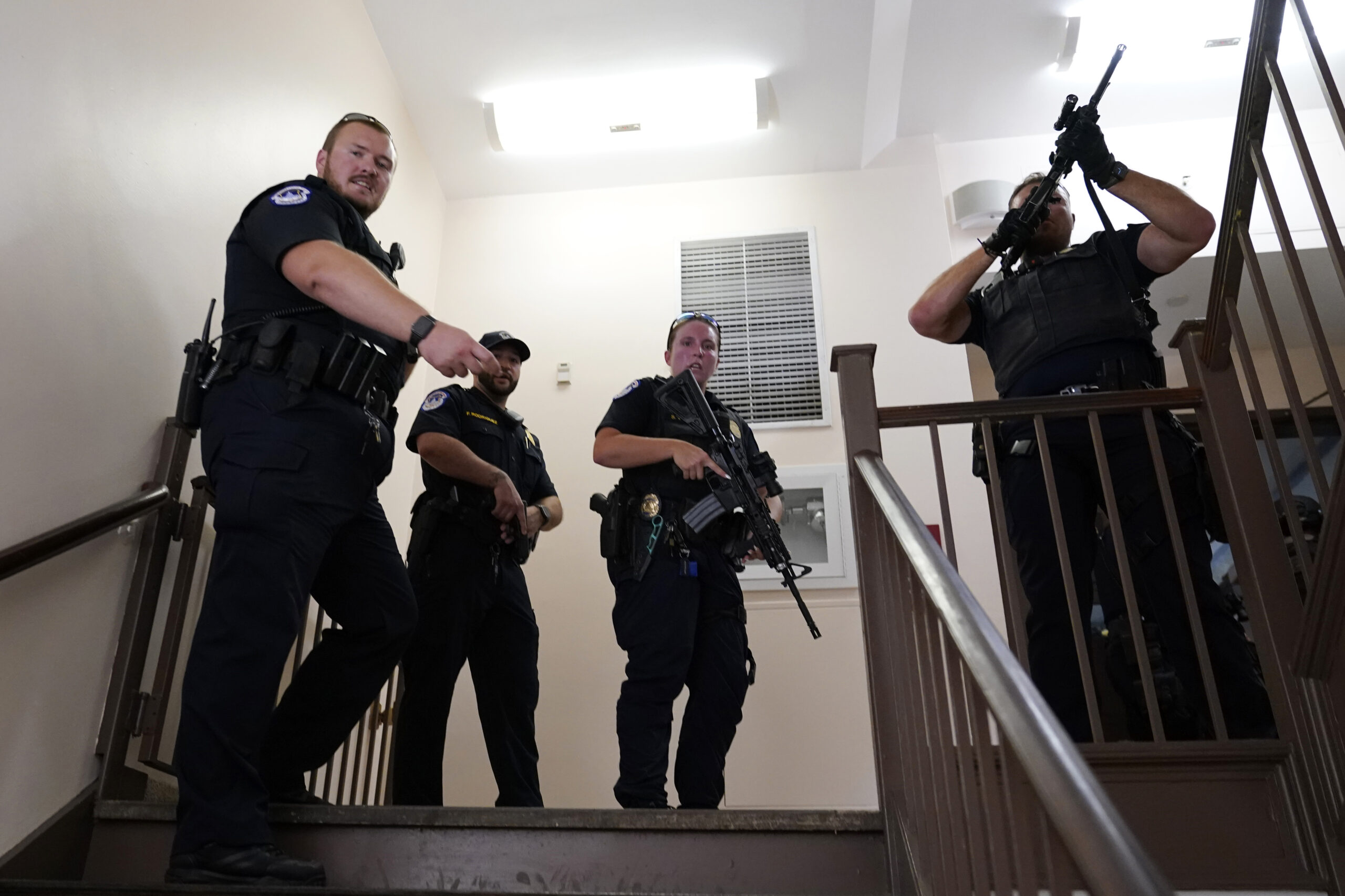 U.S. Capitol Police officers clear a stairwell in the Dirksen Senate Office Building next to the Ru...
