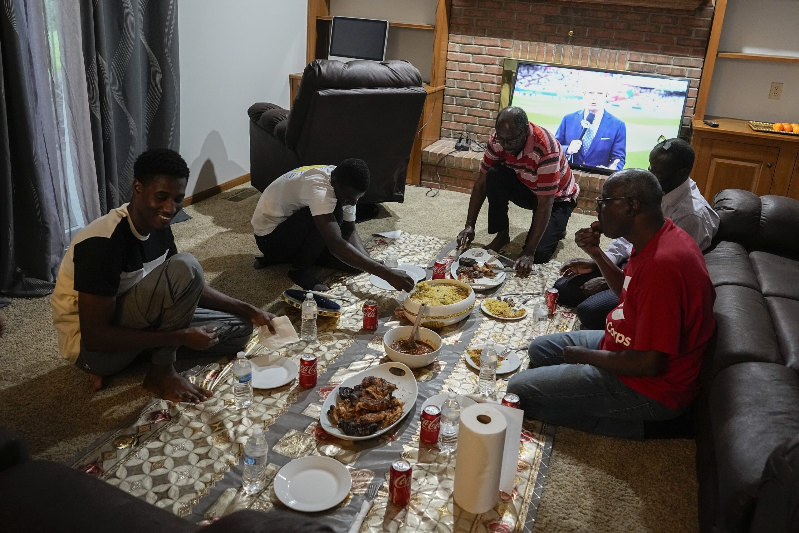 Mauritanians gather for a traditional meal, Friday, July 21, 2023, in Cincinnati. A new surge in mi...