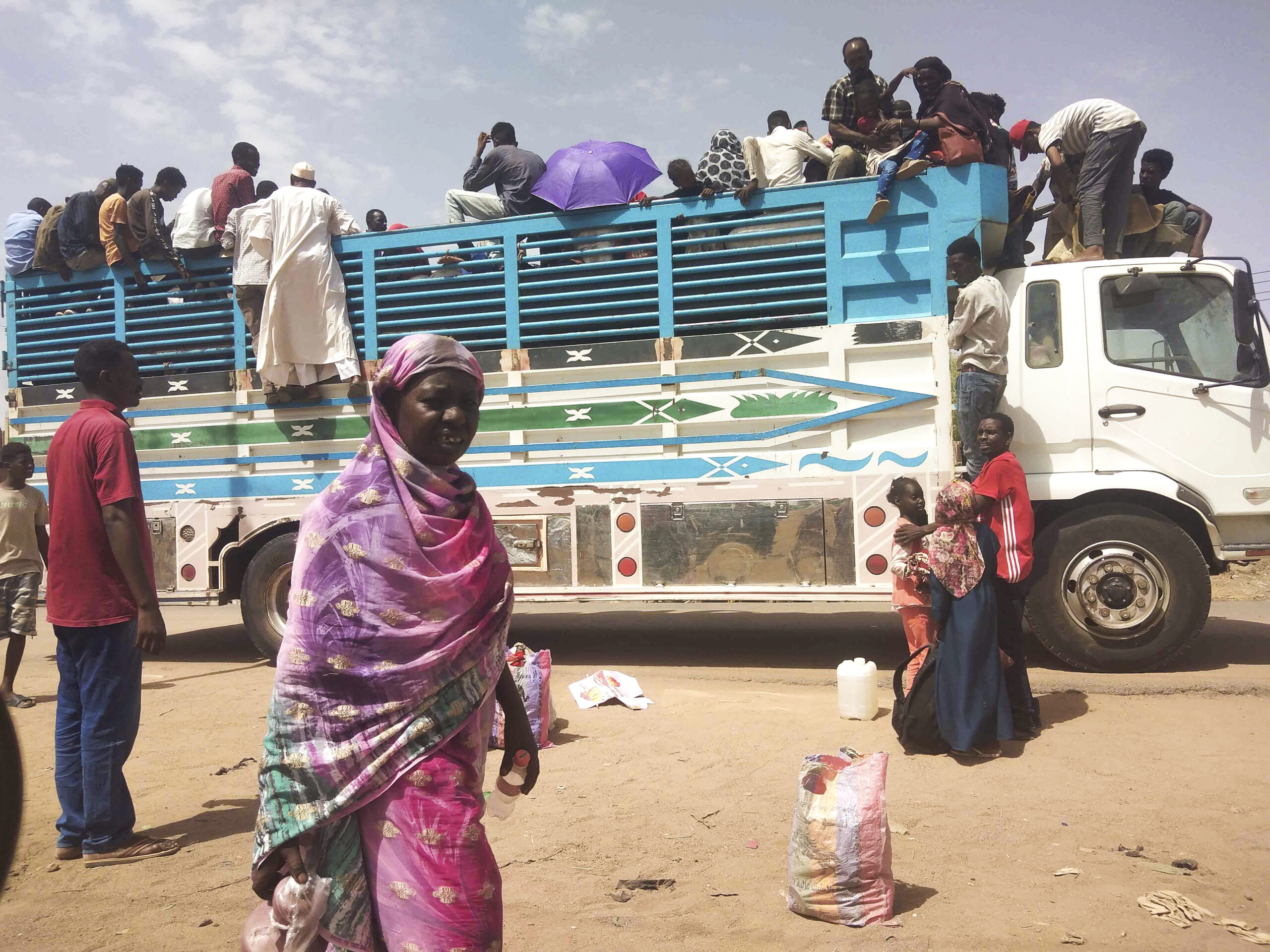 FILE - People board a truck as they leave Khartoum, Sudan, on June 19, 2023. A leading human rights...