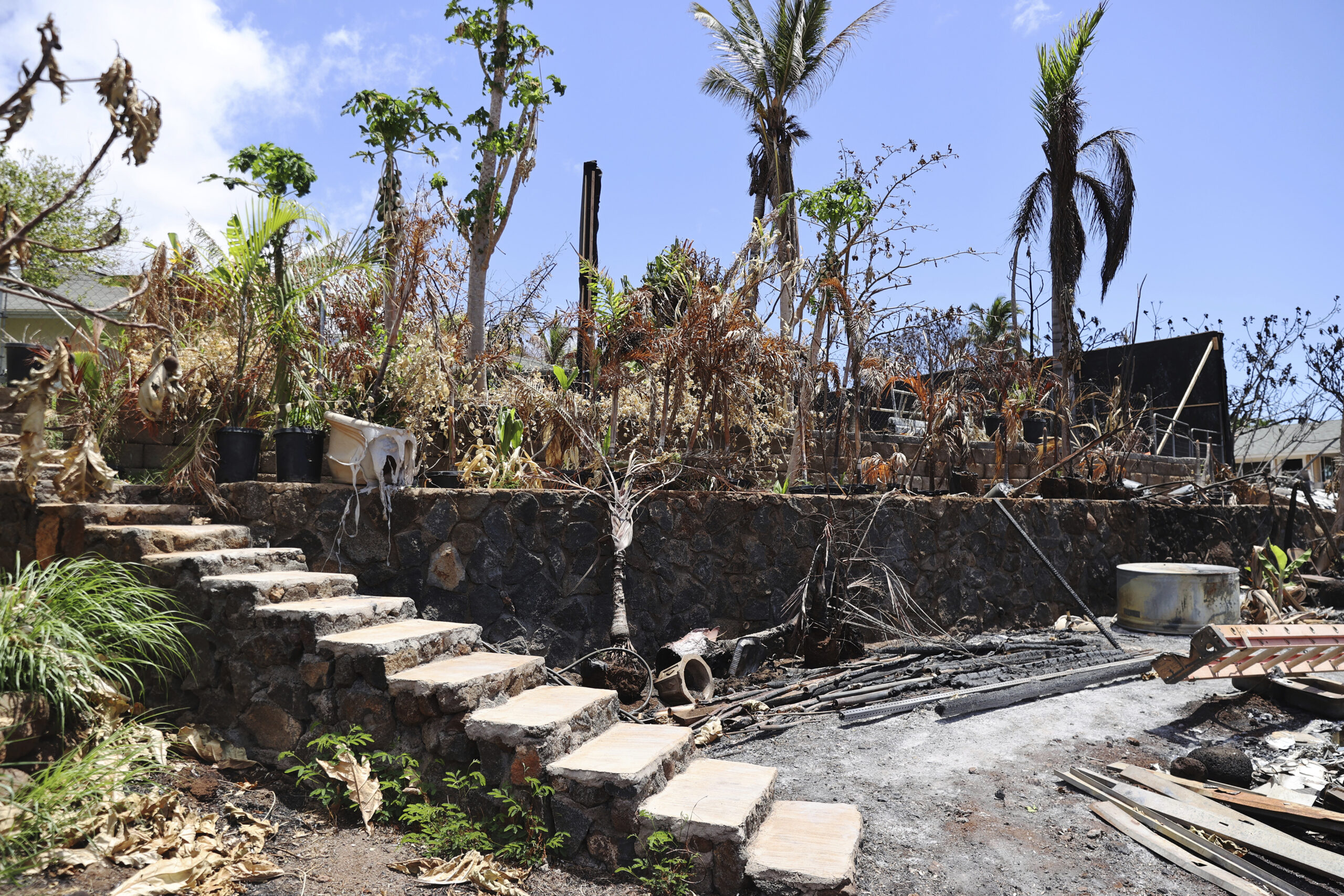 The ruins of a home destroyed by a deadly August wildfire lay outside the boundary of a Hawaiian ho...