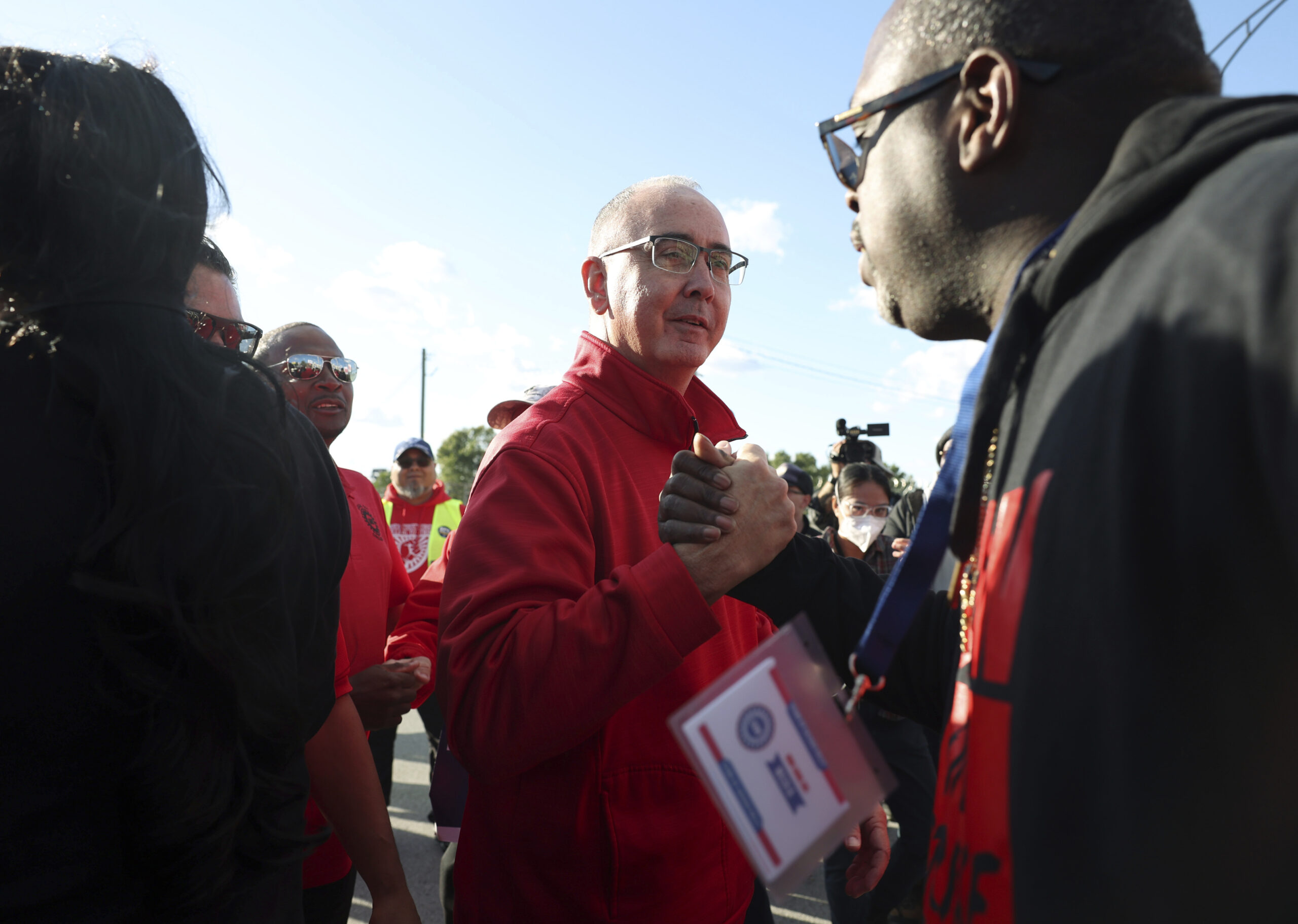File - United Auto Workers President Shawn Fain, center, visits striking UAW Local 551 workers outs...
