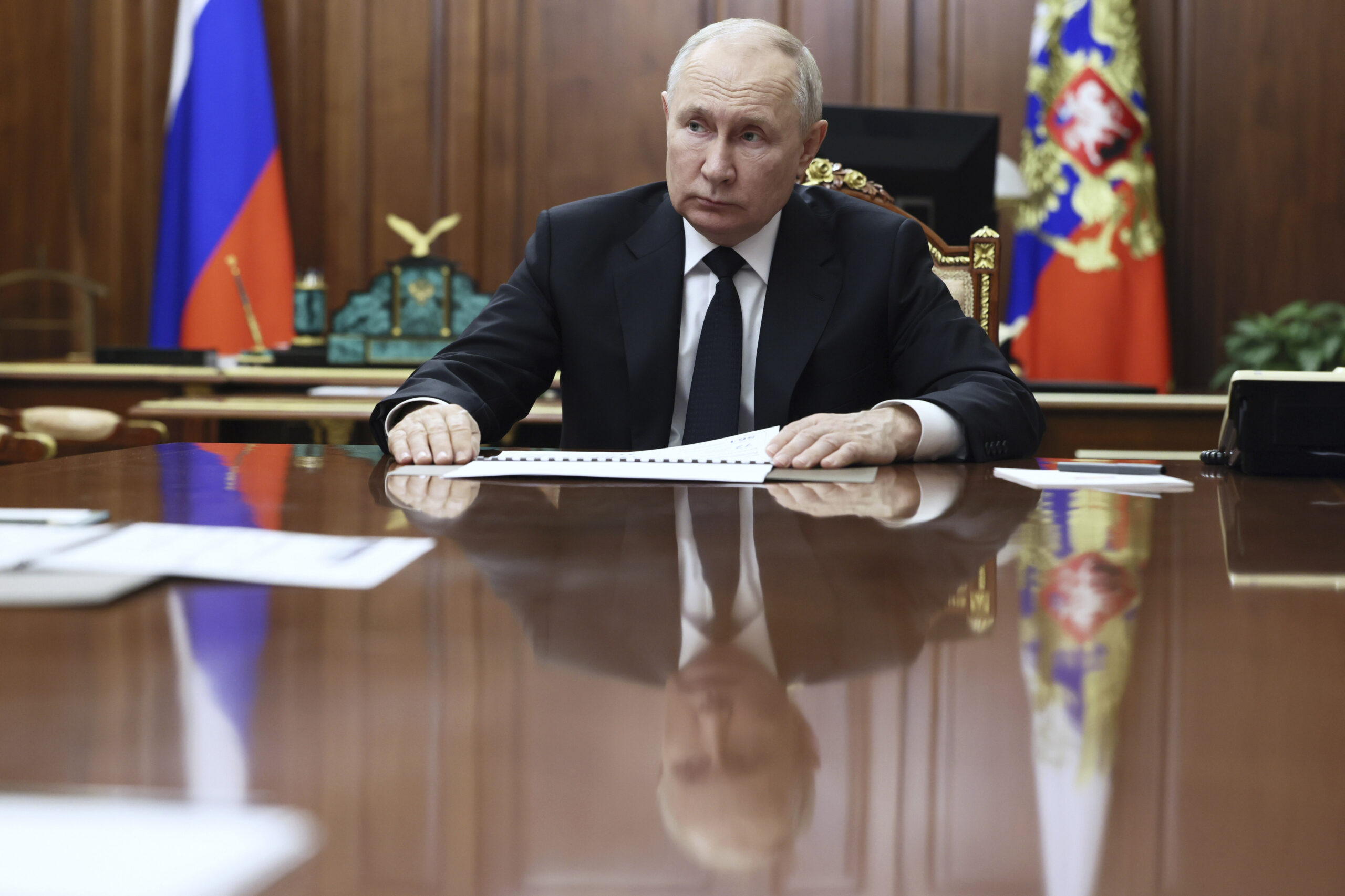 FILE - Russian President Vladimir Putin listens to Russian Deputy Prime Minister - Minister of Indu...