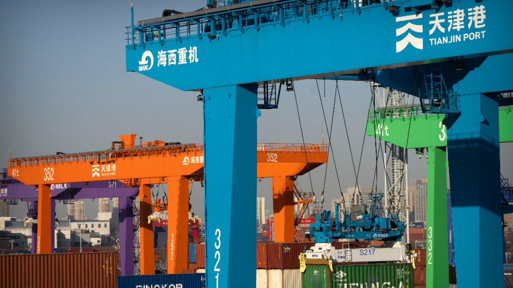 File - A crane lifts a shipping container at an automated container port in Tianjin, China, Jan. 16...