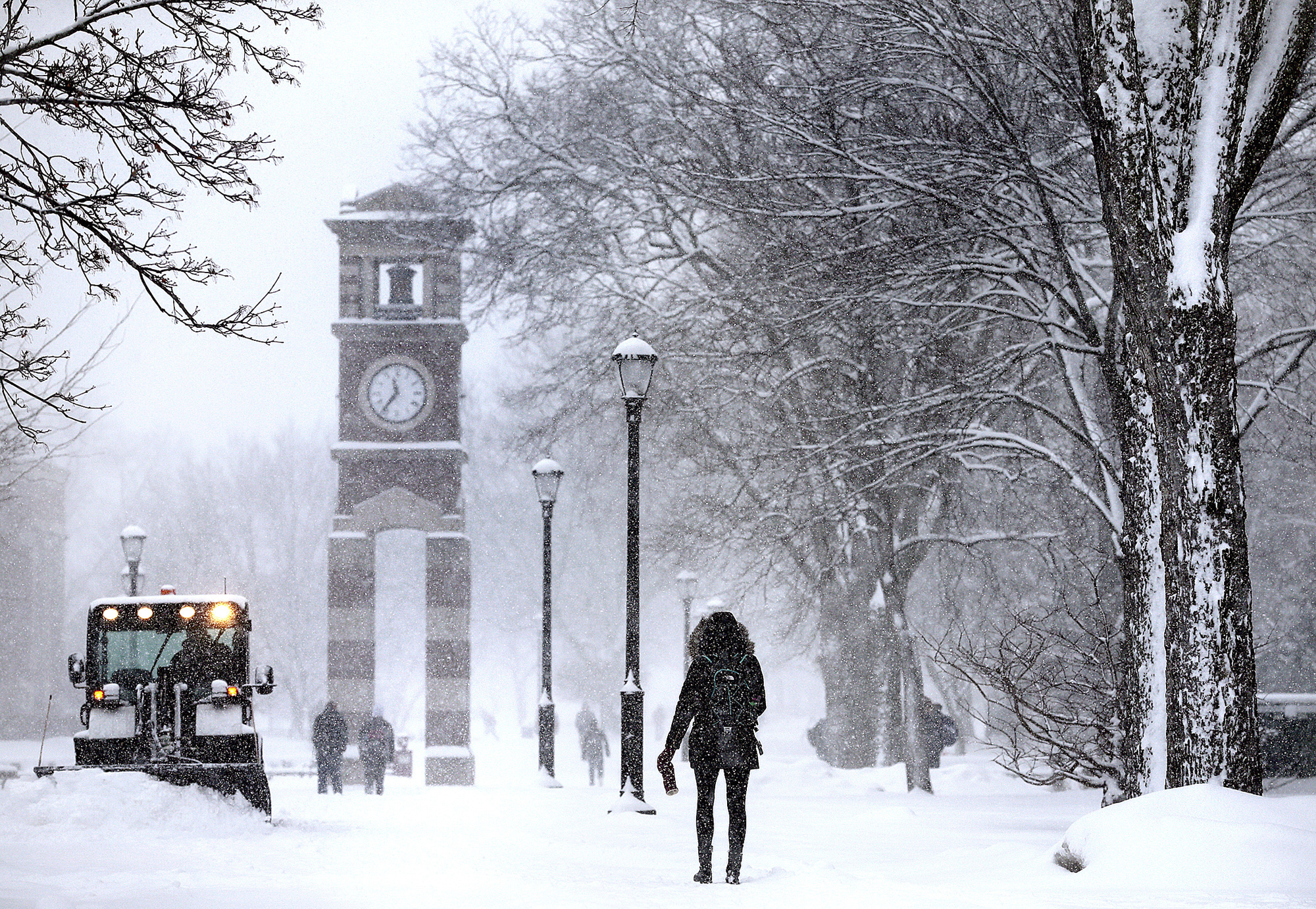 FILE - Students walk in the snow on campus at the University of Wisconsin at La Crosse as a staff m...