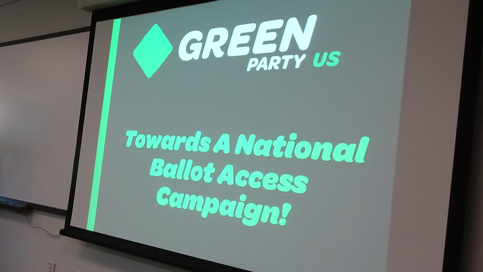 Projection on a video screen that says Green Party US Towards A National Ballot Access Campaign...