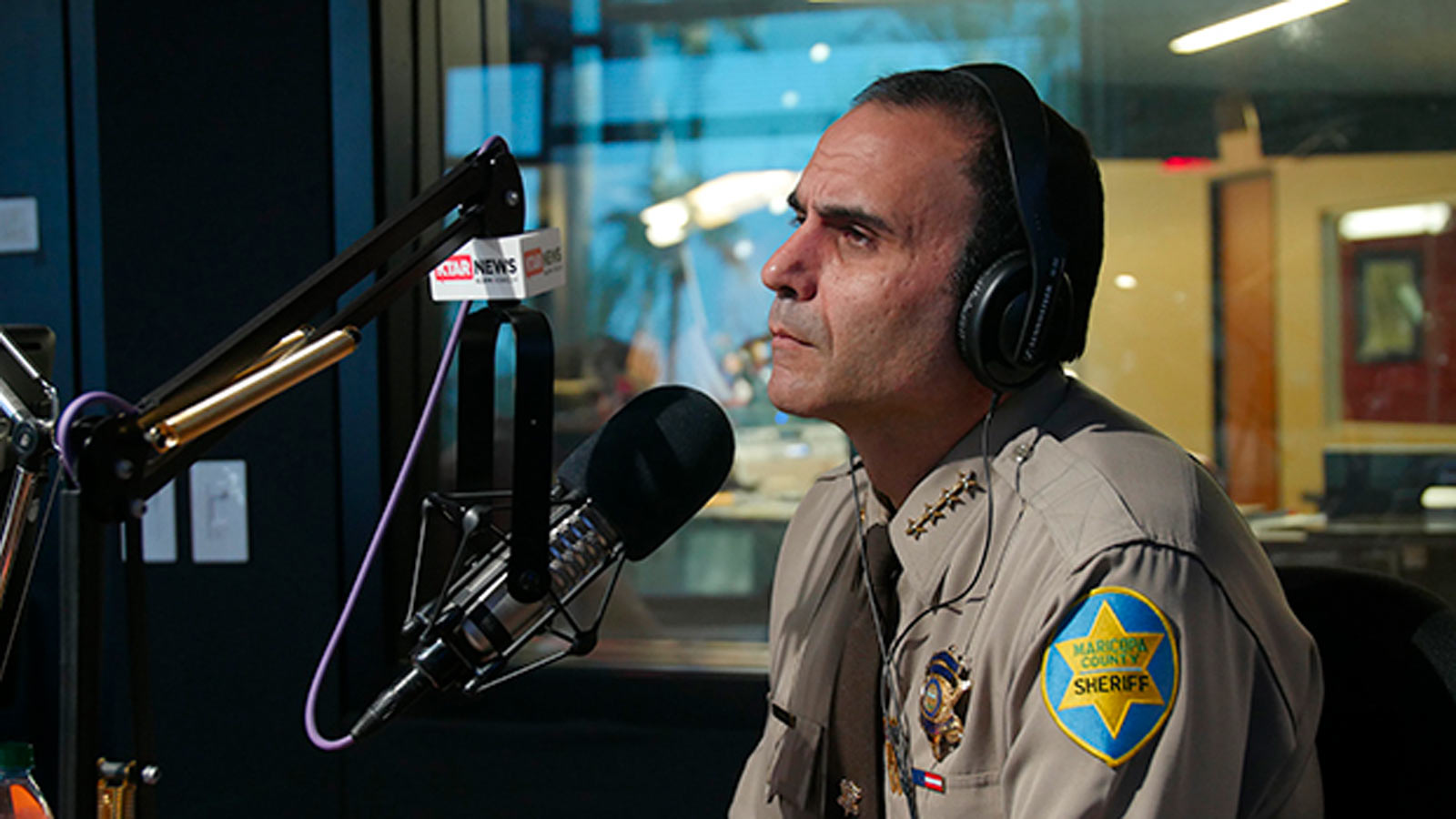 Maricopa County Sheriff Paul Penzone speaks into a microphone in the KTAR News studios in Phoenix, ...
