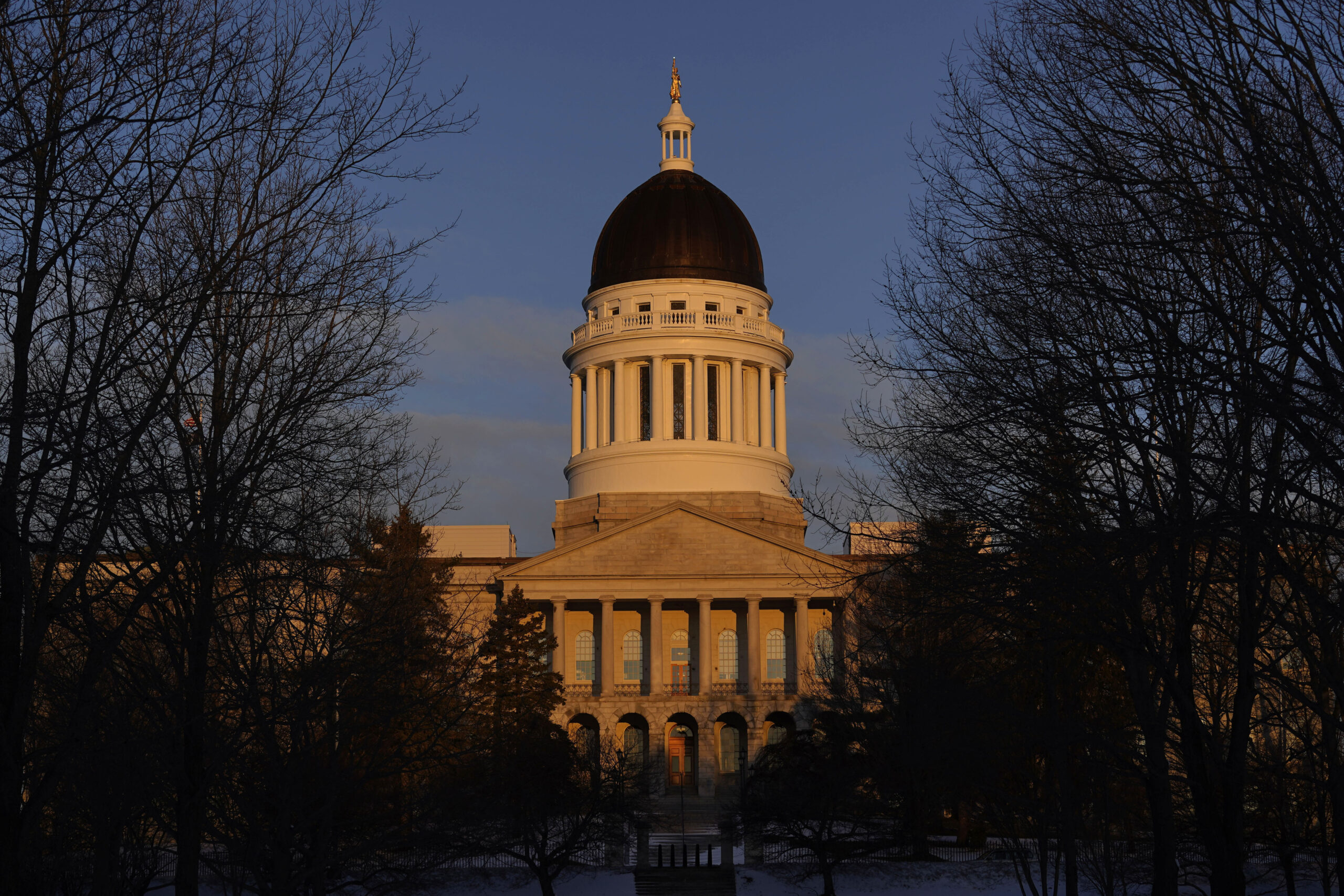 FILE - The Maine State House is seen at sunrise, March 16, 2023, in Augusta, Maine. Honoring victim...