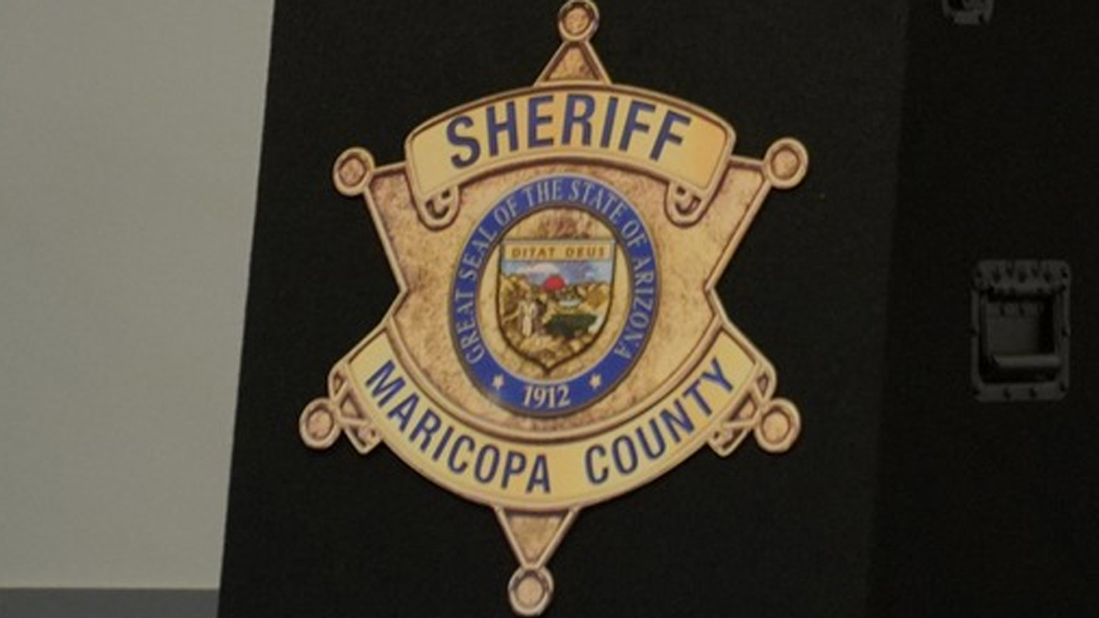 Shield log of the Maricopa County Sheriff's Office on the front of a lectern....
