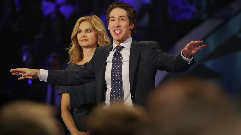 Joel Osteen, the pastor of Lakewood Church, stands with his wife, Victoria Osteen, as he conducts a...