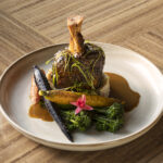 The Tamarind Braised Pork Shank featuring white corn grits, charred broccolini,
roasted baby carrots, rosemary and pomegranate chermoula. (The Westin Kierland Resort & Spa)