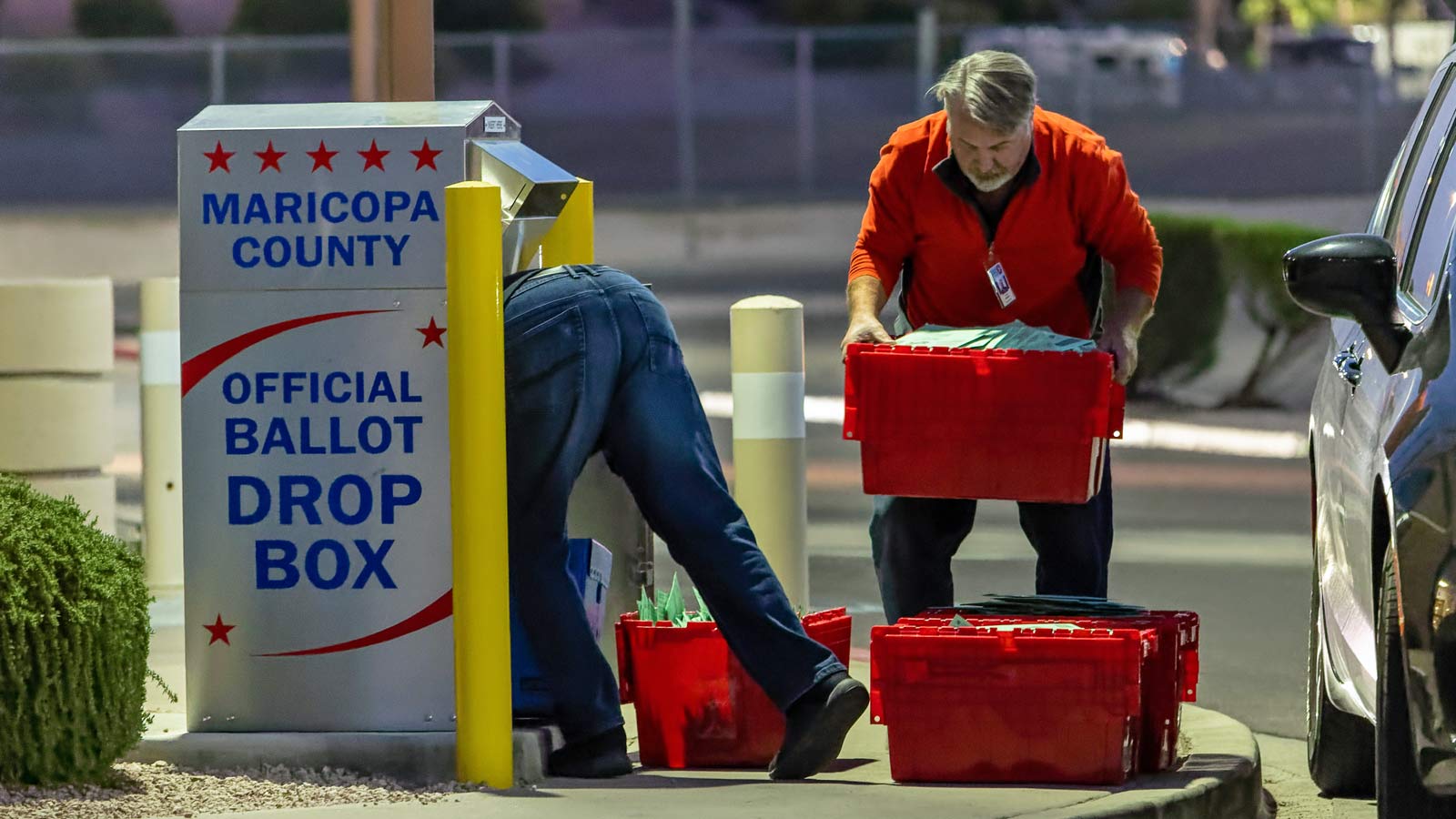 Maricopa County election workers remove ballots from a drop box on Nov. 8, 2022, in Mesa, Arizona....