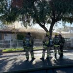 Phoenix firefighters examine a home on fire. (Phoenix Fire Department photo)