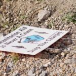 A sign lays on the ground near the border in Arivaca, Arizona. (KTAR News Photo/Felisa Cardenas)
