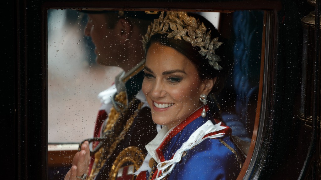 FILE - Kate, Princess of Wales and Prince William travel in a coach following the coronation ceremo...