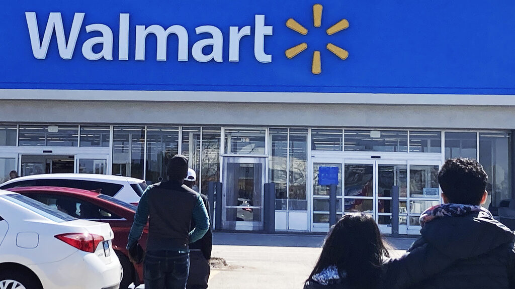 Shoppers walk to a Walmart in Vernon Hills, Ill., Tuesday, March 28, 2023. Don't count on a favorit...