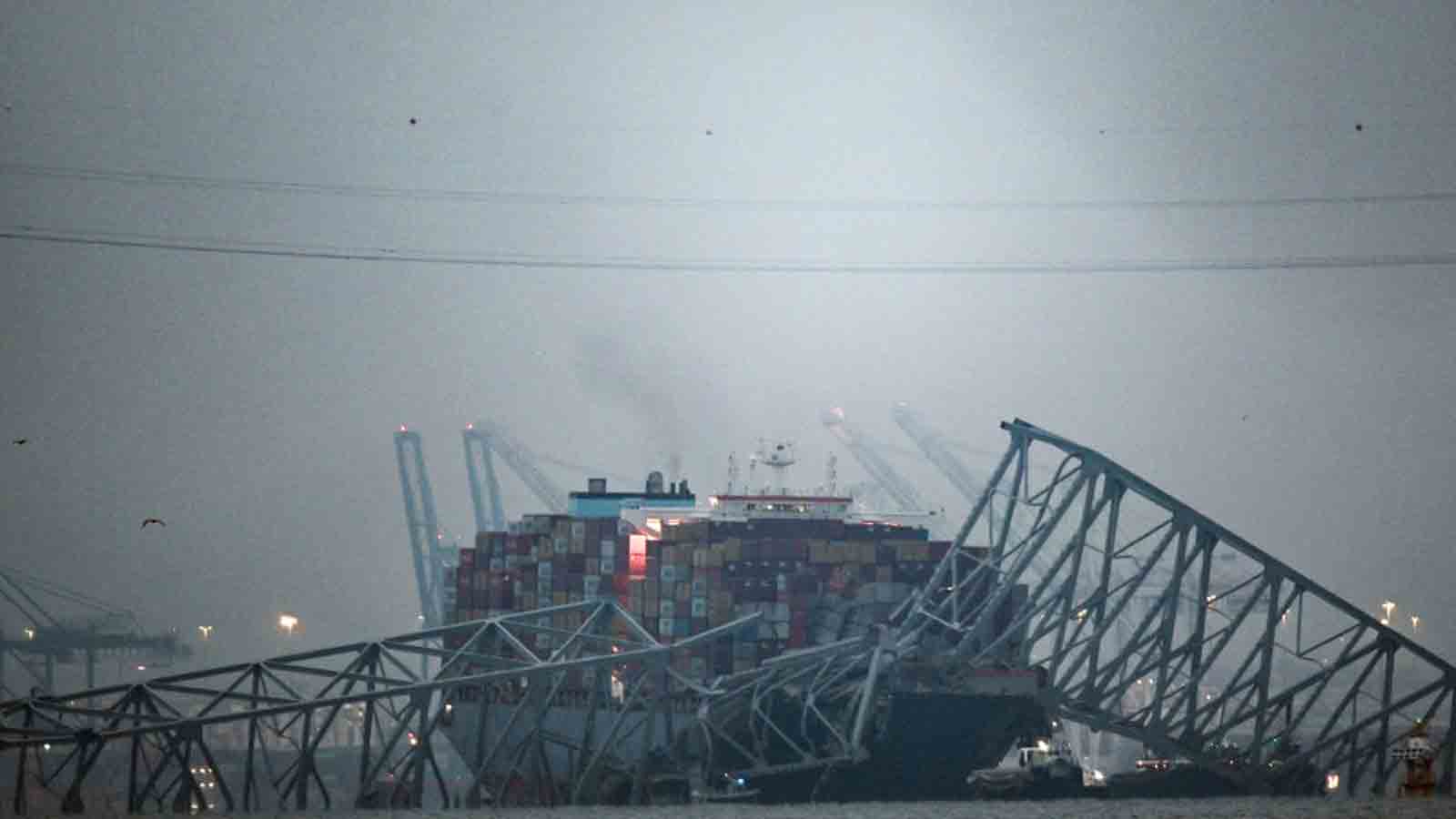 The collapsed Francis Scott Key Bridge lies on top of the container ship Dali in Baltimore, Marylan...