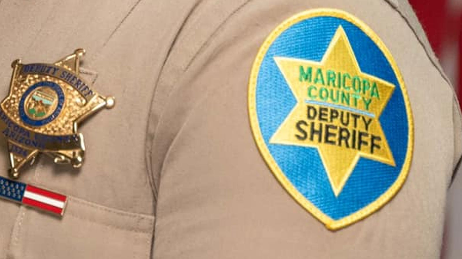 Closeup showing the badge and patch on the uniform of a Maricopa County Sheriff's Office deputy. Tw...