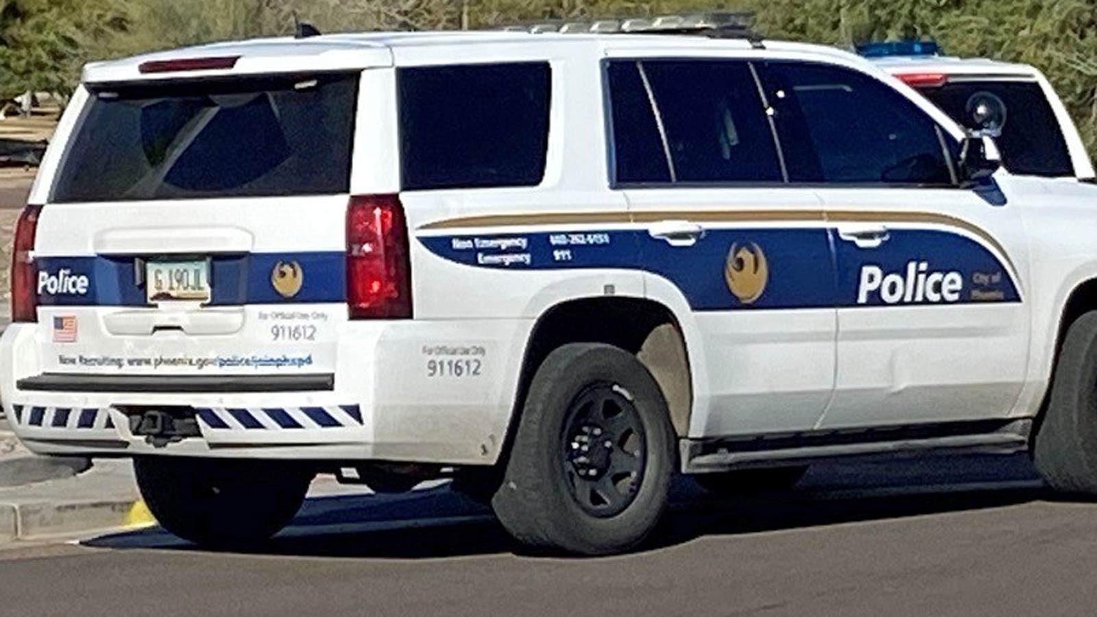 File photo of Phoenix police SUVs parked on the side of a road...