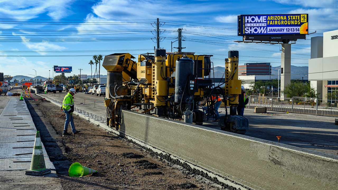Construction crews pour concrete for walls along State Route 143 in Phoenix, Arizona....