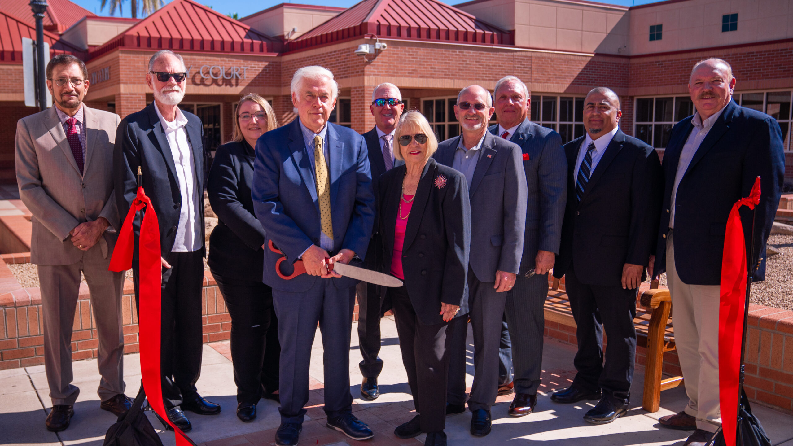 Glendale Mayor Jerry Weiers holds the supersized scissors at the ribbon cutting at Glendale's newly...