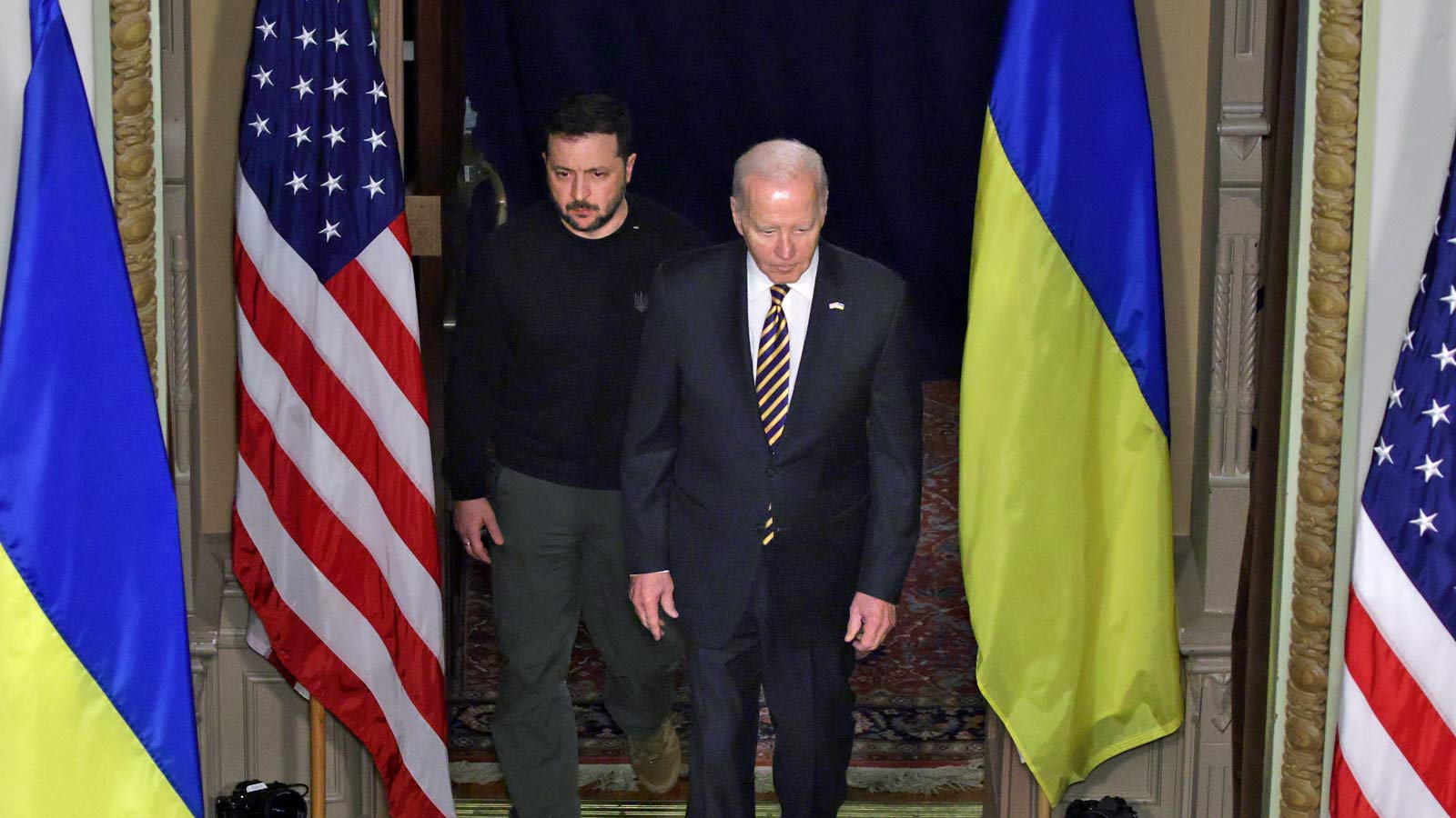 Ukrainian President Volodymyr Zelensky, left, and U.S. President Joe Biden arrive for a news confer...