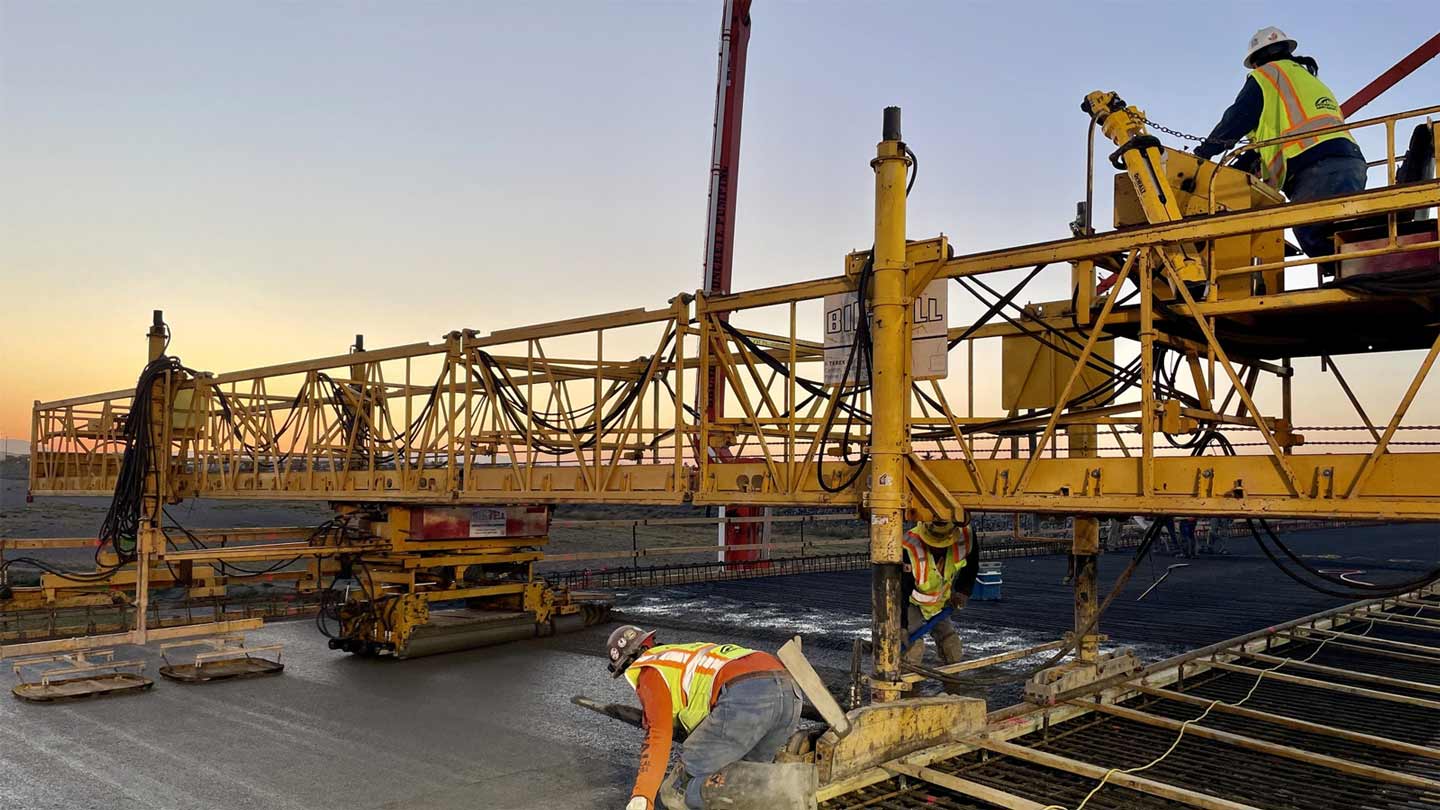 Arizona Department of Transportation crews are seen pouring concrete for a bridge deck as part of t...