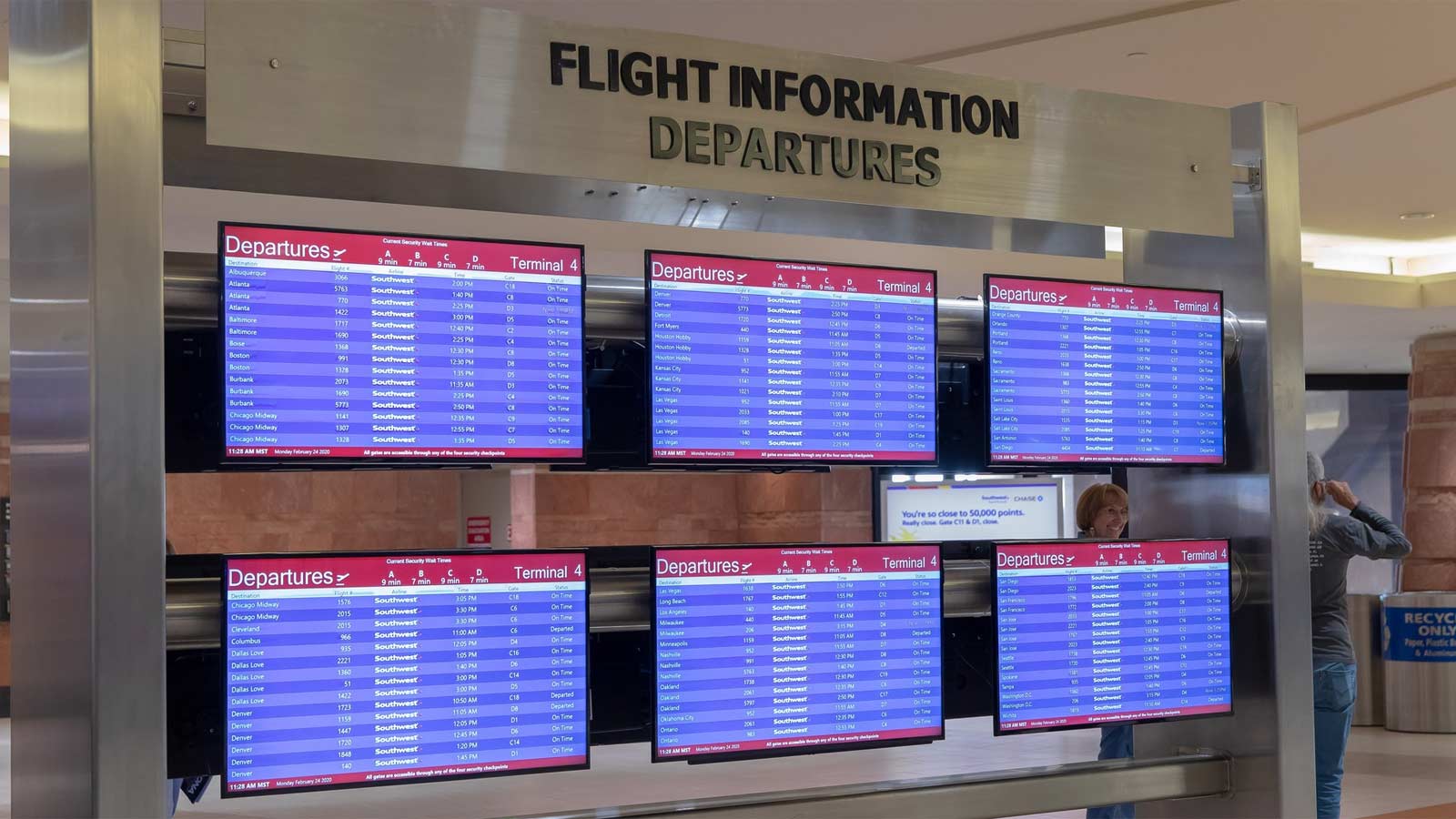 A file photo shows flight information monitors at Phoenix Sky Harbor International Airport...