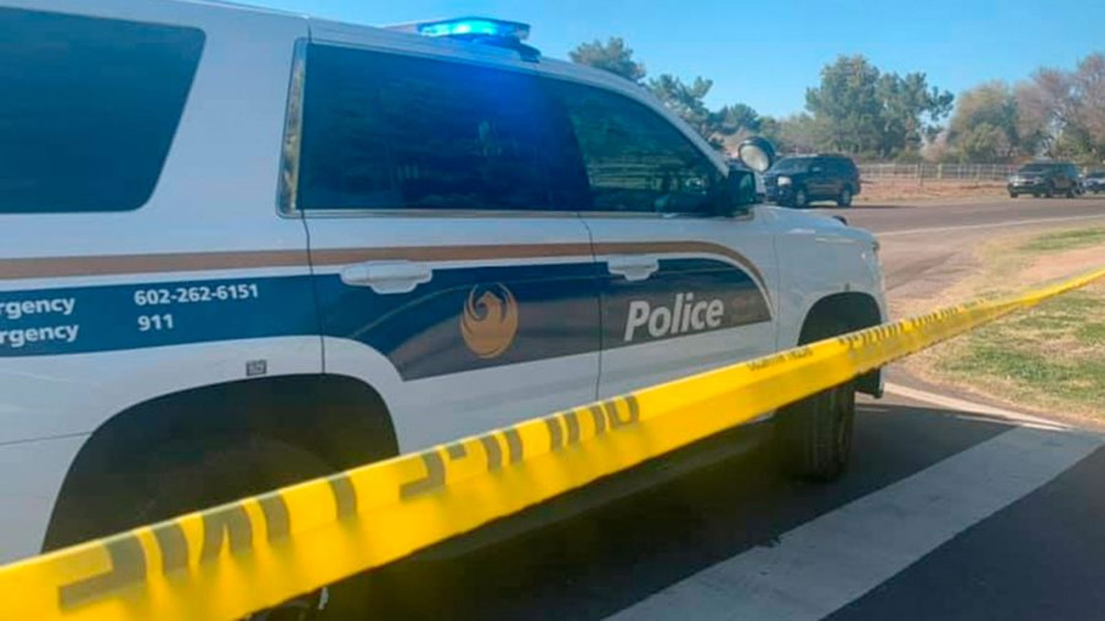File photo of a Phoenix Police SUV parked next to yellow crime scene tape. Police responded to rPol...