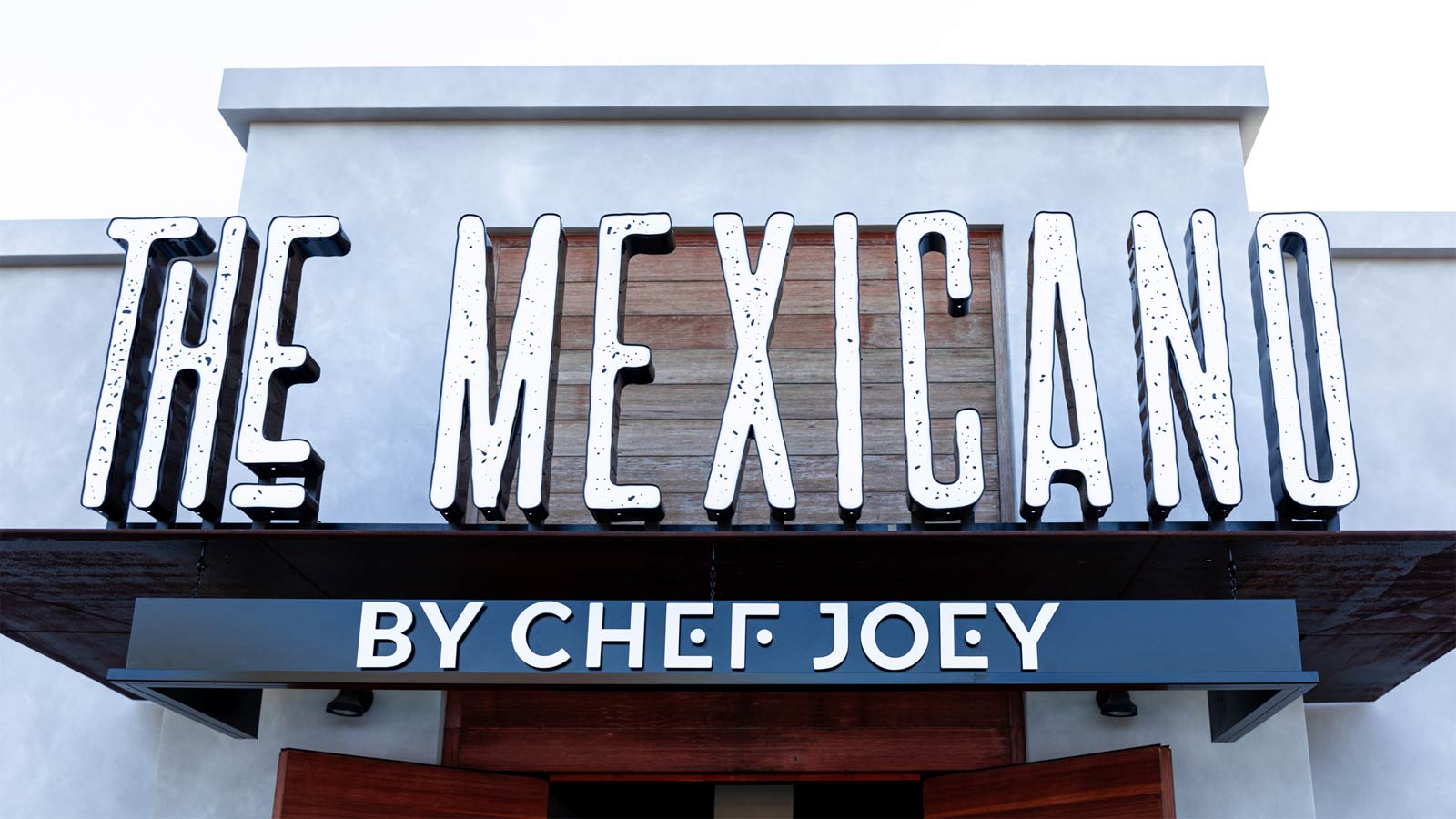 A sign at the front of The Mexicano in Phoenix shows the restaurant's name with the words "By Chef ...