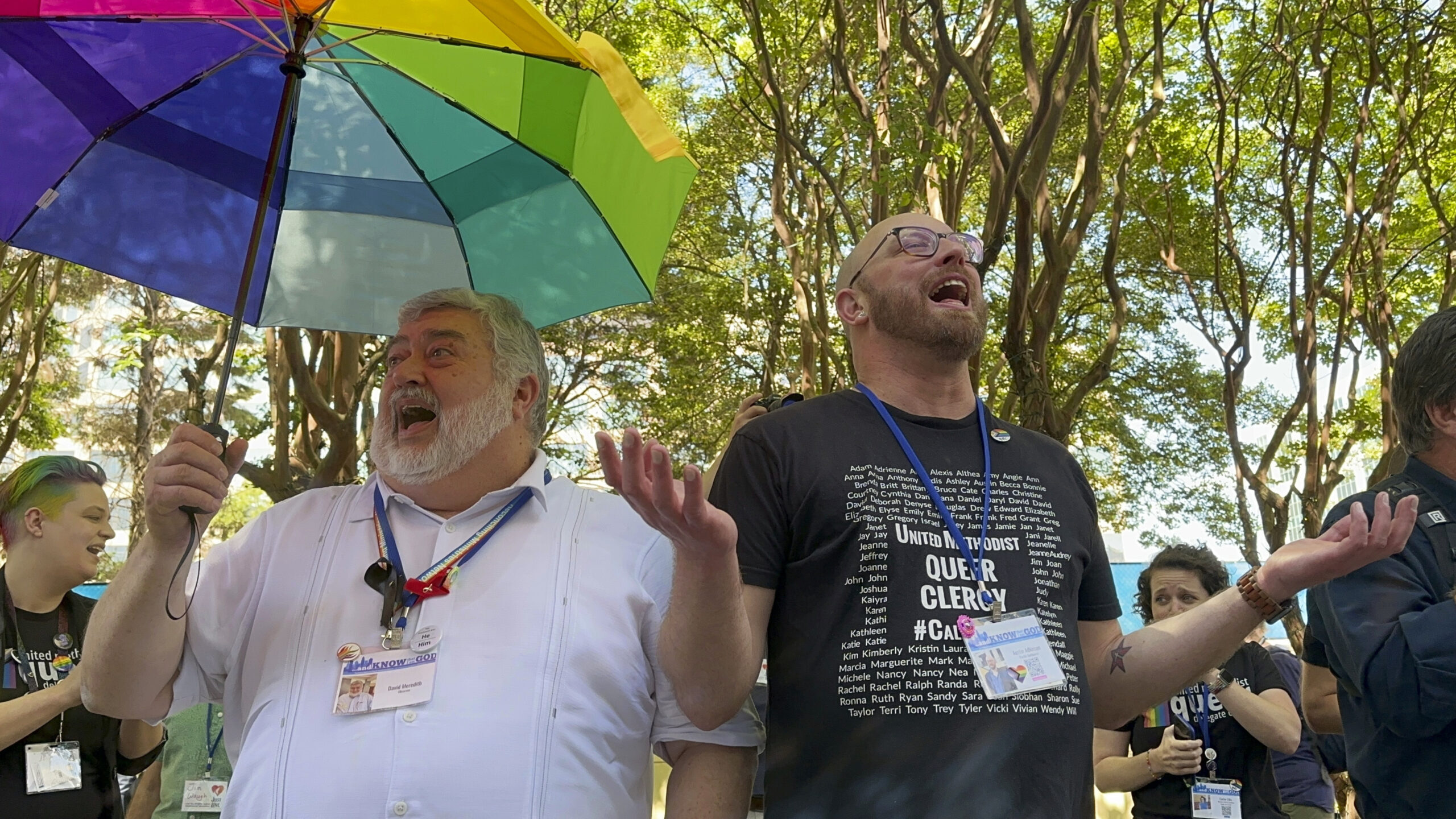 The Rev. David Meredith, left, and the Rev. Austin Adkinson sing during a gathering of those in the...