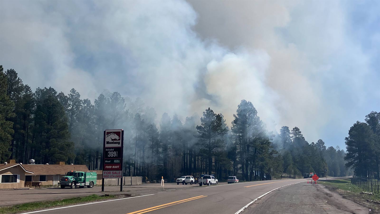 Smoke can be seen coming from a forest next to an Arizona highway. A section of State Route 87 in n...