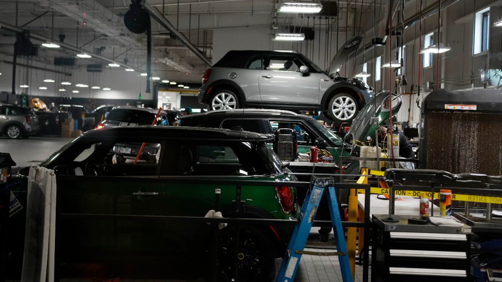 FILE - Cooper models are tended to in the service bay of a Mini dealership Nov. 3, 2022, in Highlan...
