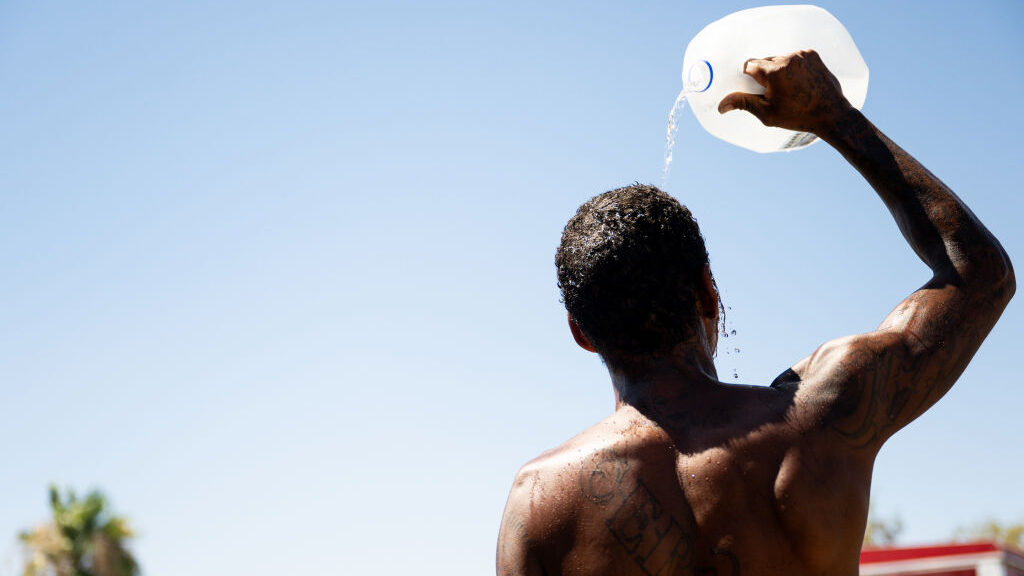 A person cools off amid searing heat in Phoenix, Arizona. (Photo by Brandon Bell/Getty Images)...