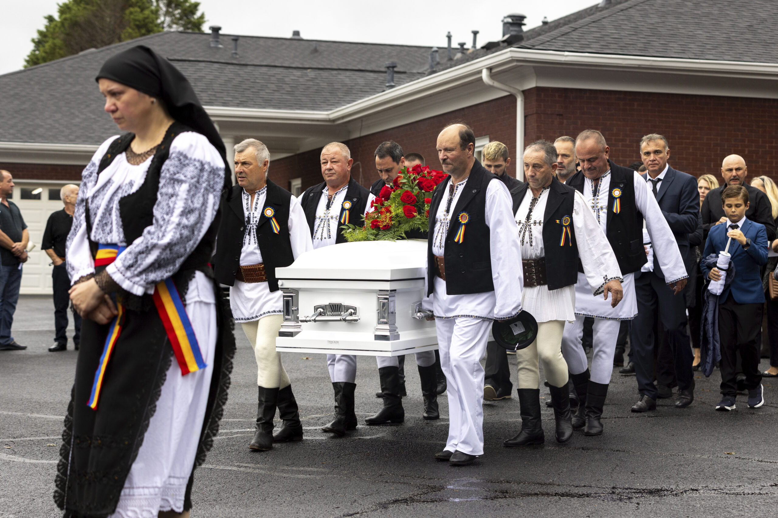 Mourners carry the casket of Ana Cristina Irimie, a math teacher killed during a shooting at Apalac...