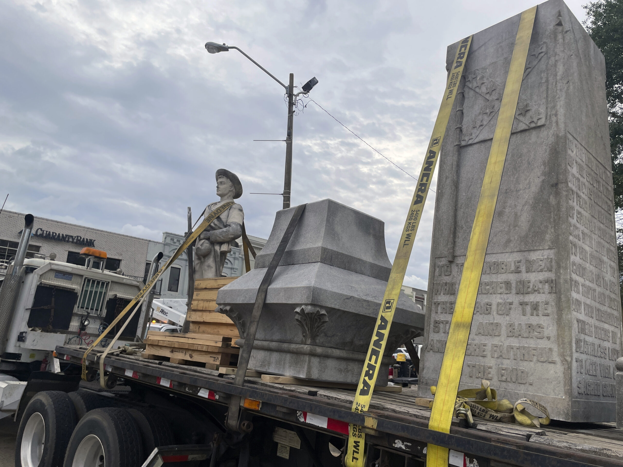 Pieces of a Confederate monument are secured onto a flatbed truck Wednesday, Sept. 11, 2024, after ...