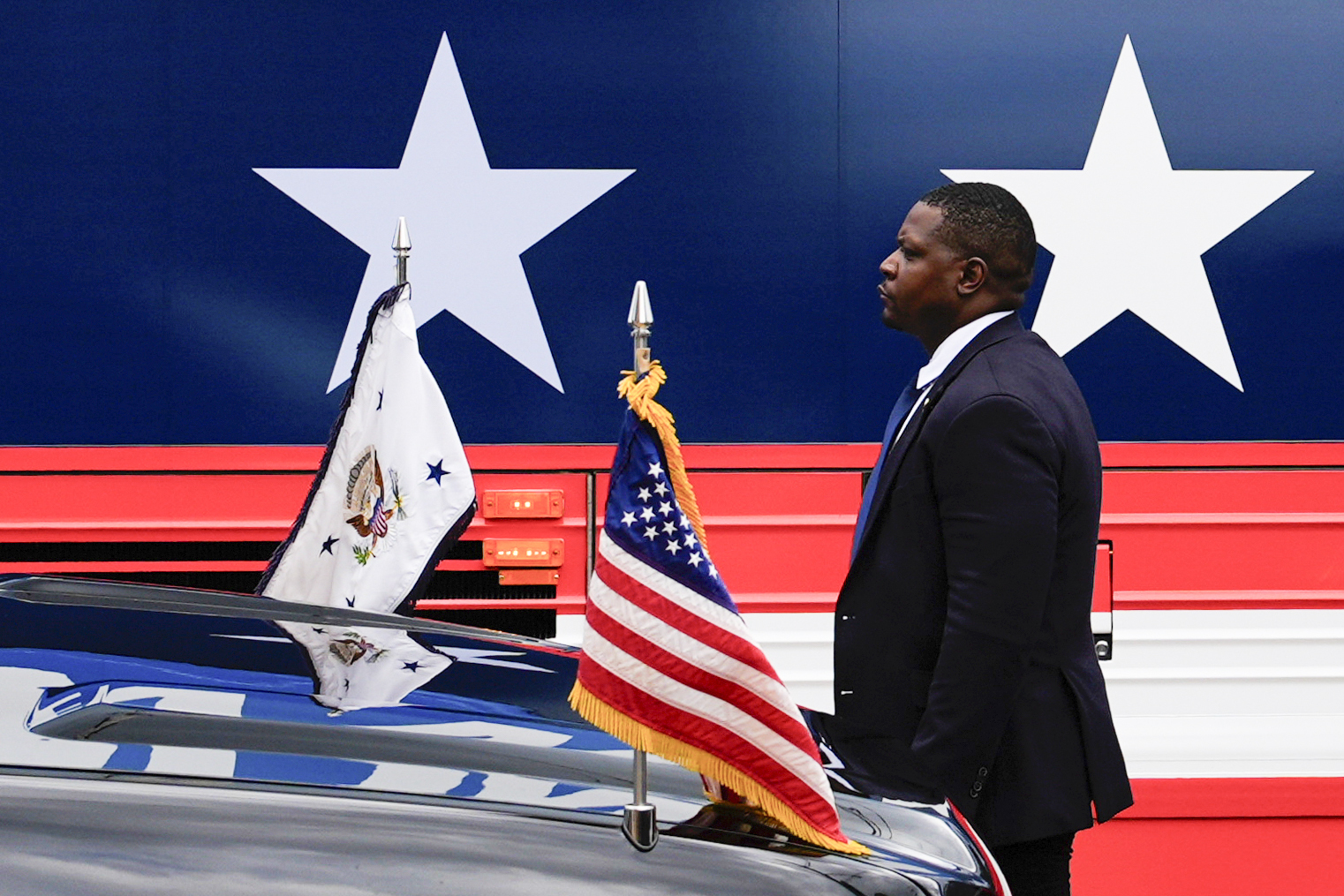 FILE - A U.S. Secret Service agent stands watch outside a campaign bus for Democratic presidential ...