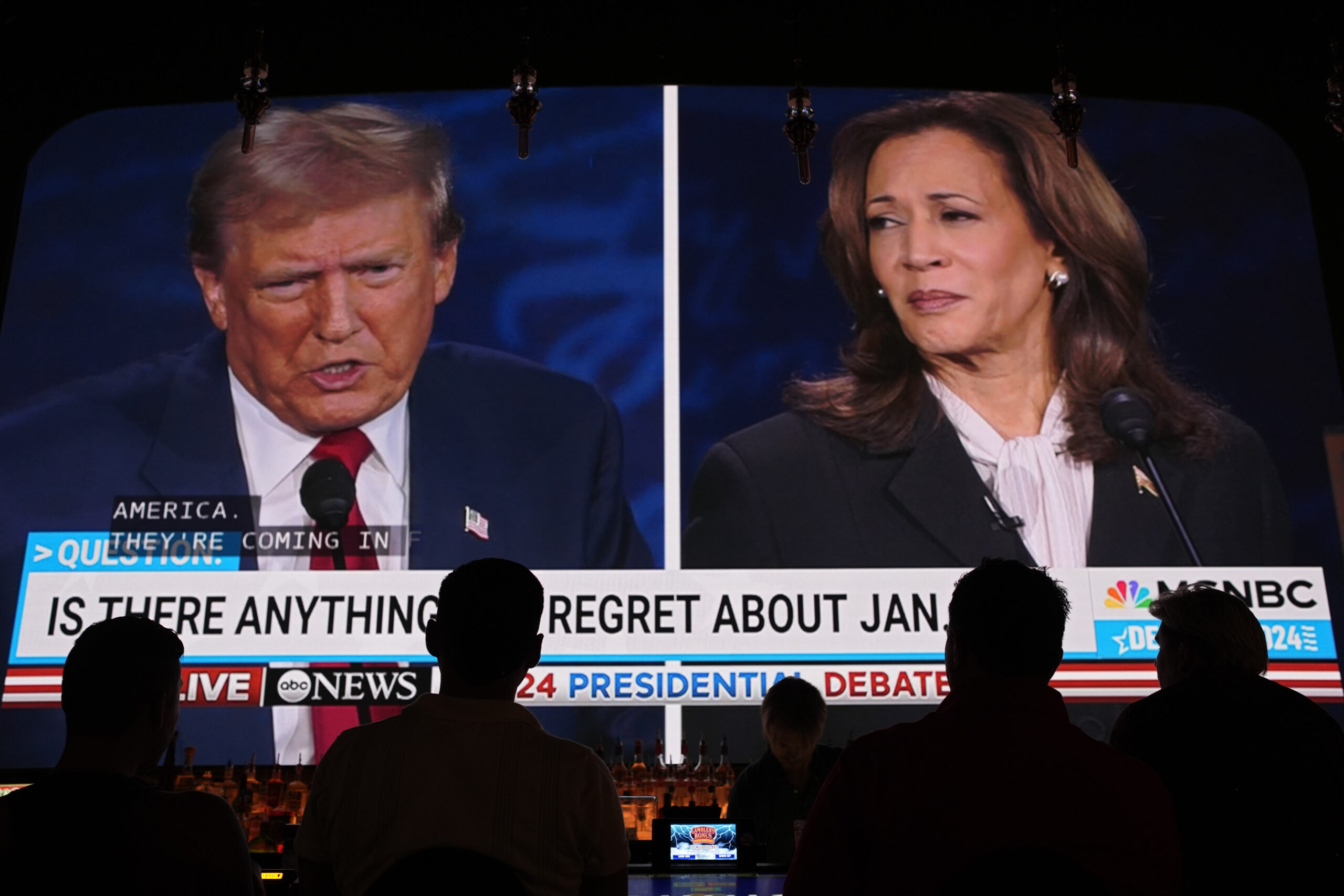 People watch the presidential debate between Republican presidential nominee former President Donal...