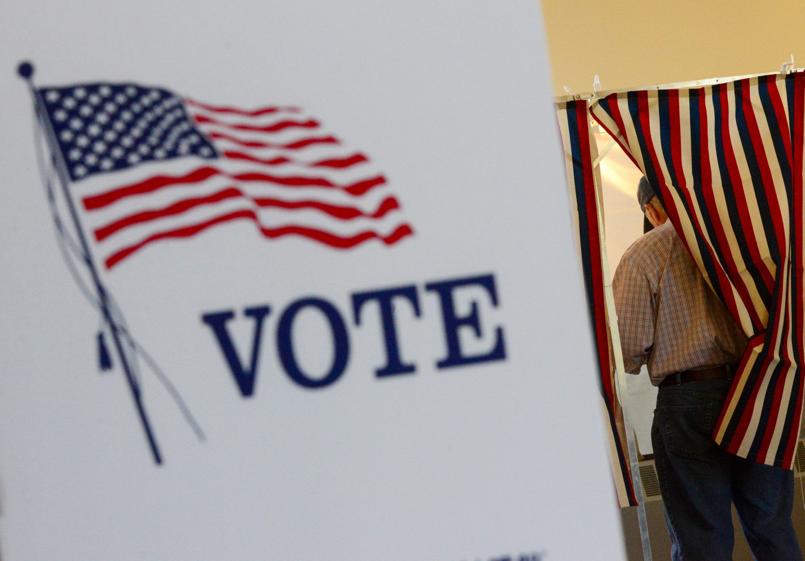 Lyell Williams of Chesterfield, N.H., fills out his ballot during the New Hampshire state primaries...