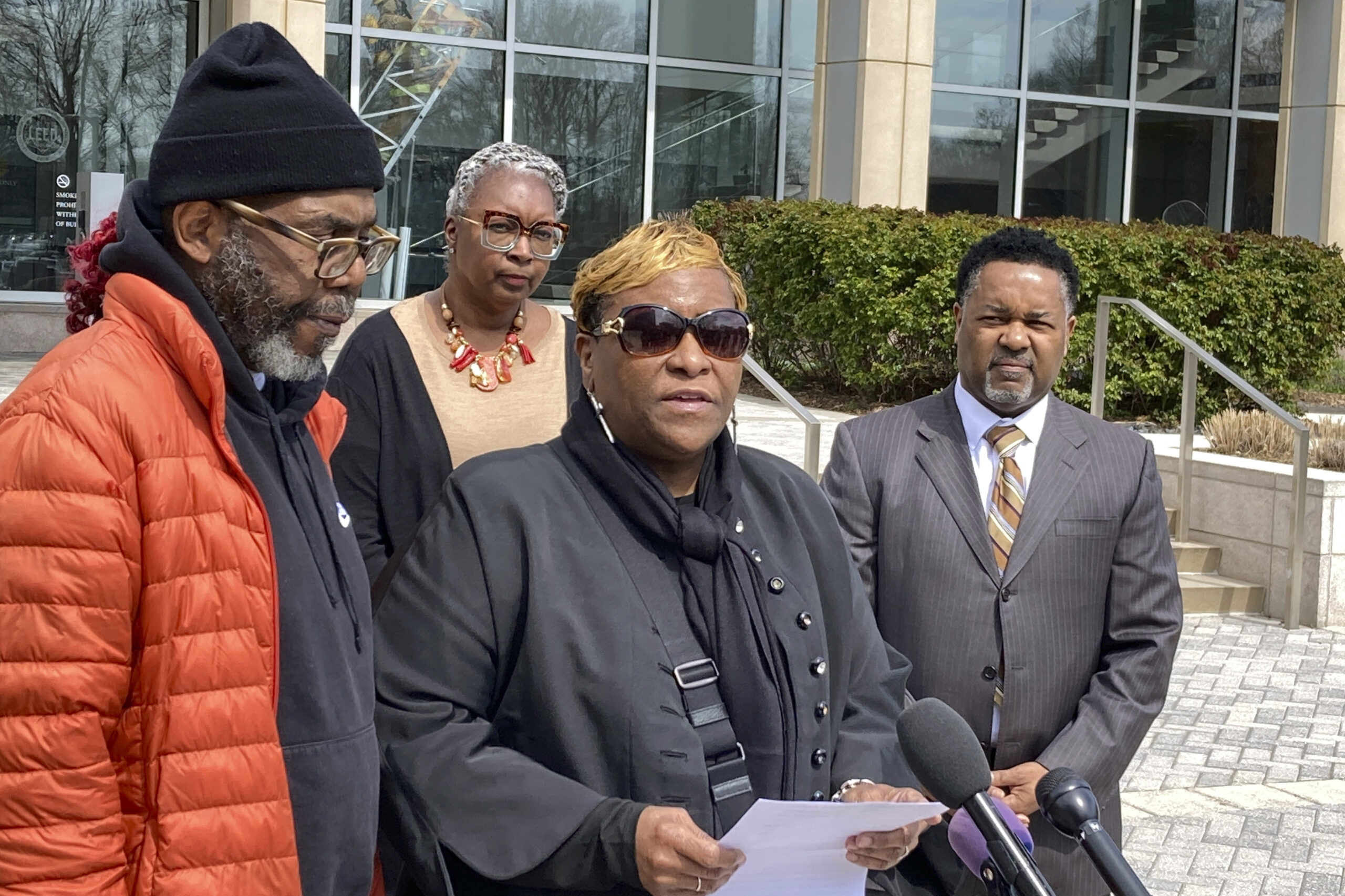 FILE - Timothy McCree Johnson's parents Melissa Johnson, center, and Timothy Walker, left, address ...