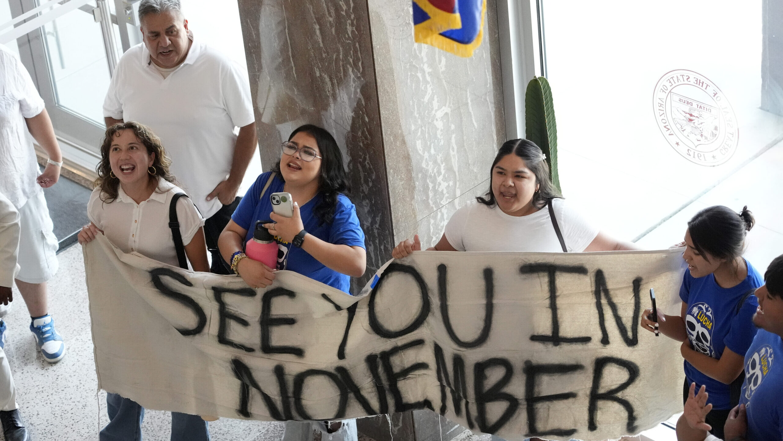 FILE - Opponents to an immigration proposal gather inside the Arizona State Capitol, Tuesday, June ...