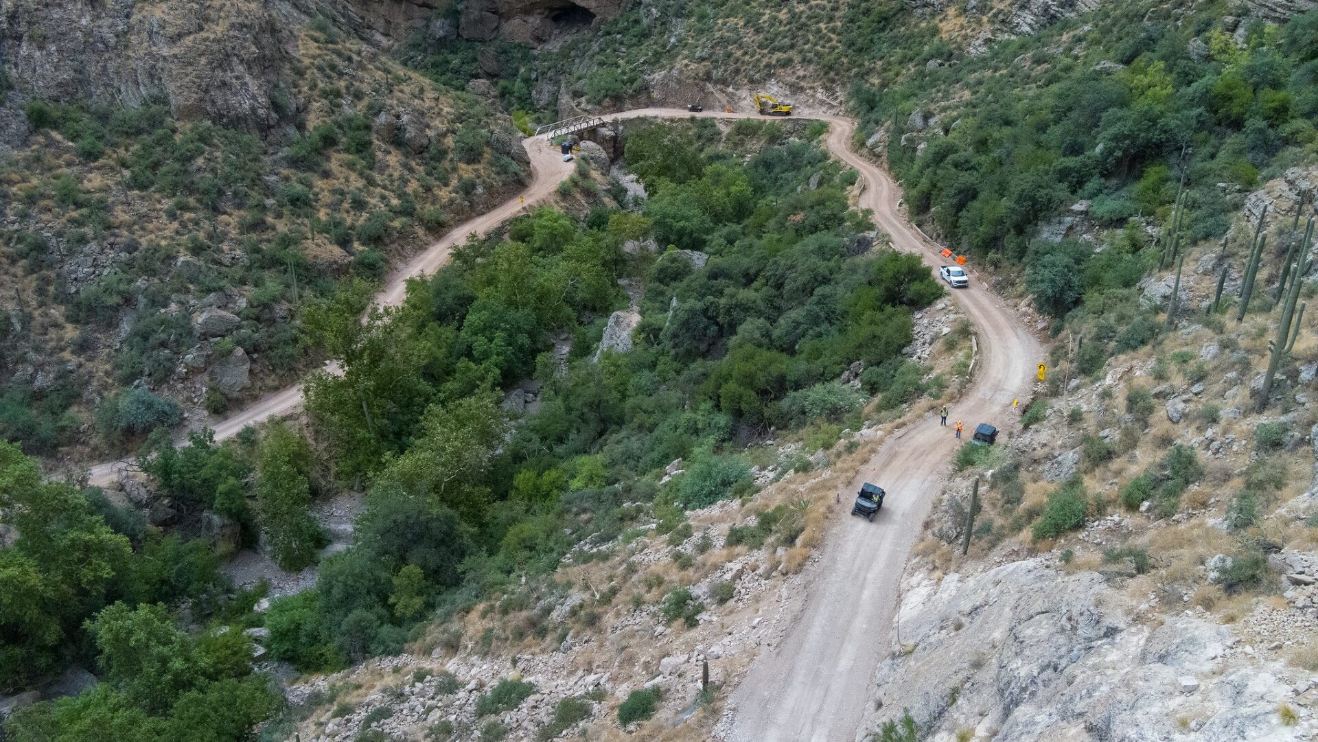 A road curves through a desert mountainside...